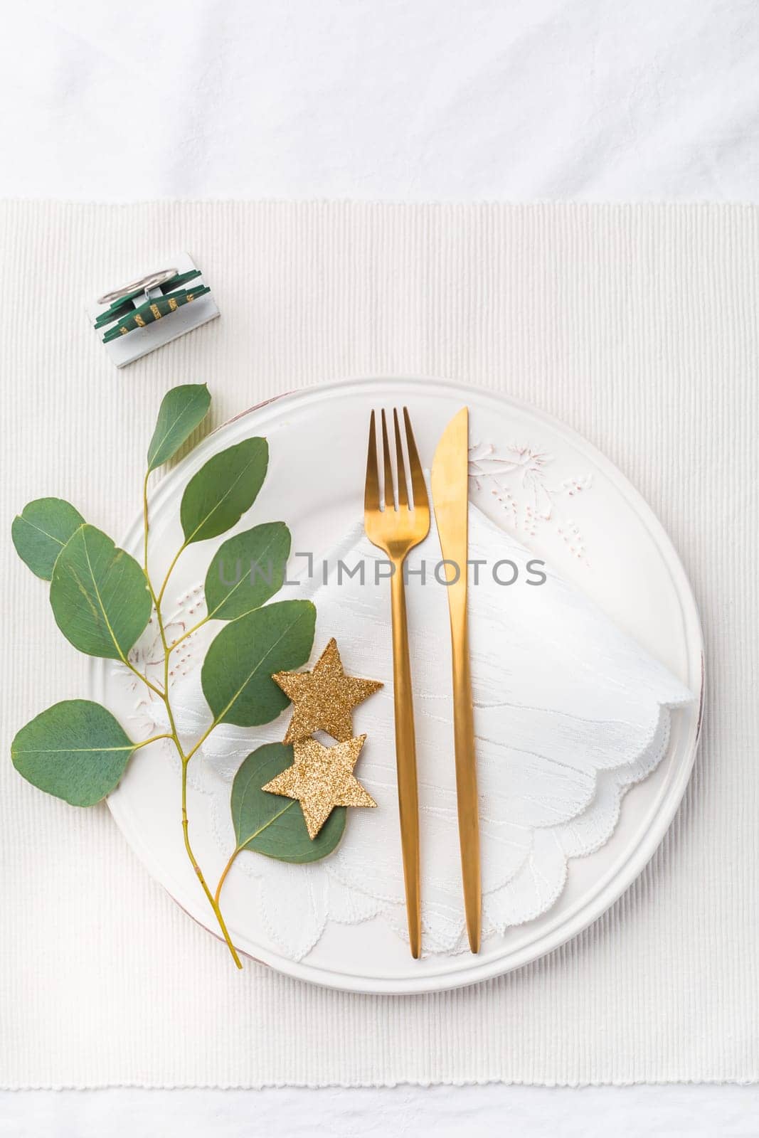 Christmas table setting with cutlery in white tone