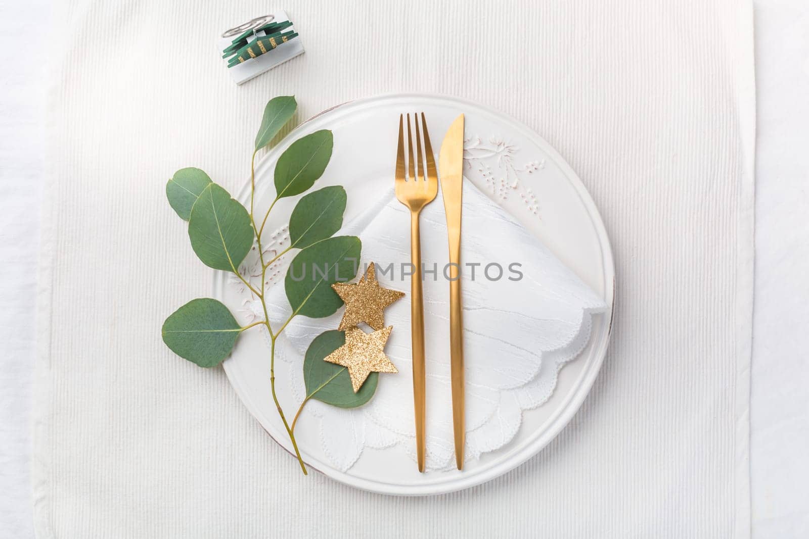 Christmas table setting with cutlery in white tone