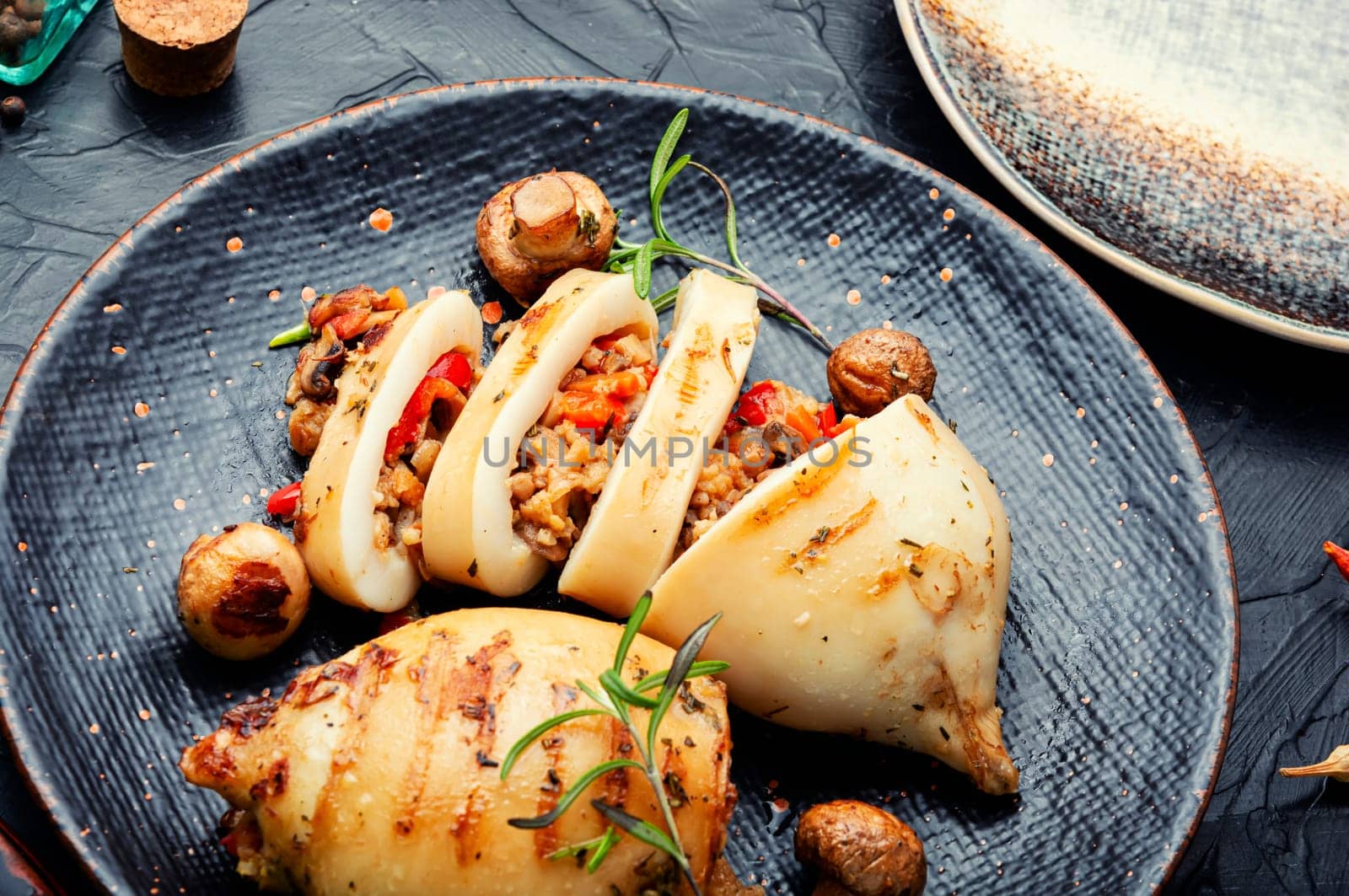 Appetizing grilled squids with vegetable stuffing. Roasted stuffed squid. Mediterranean dish, top view