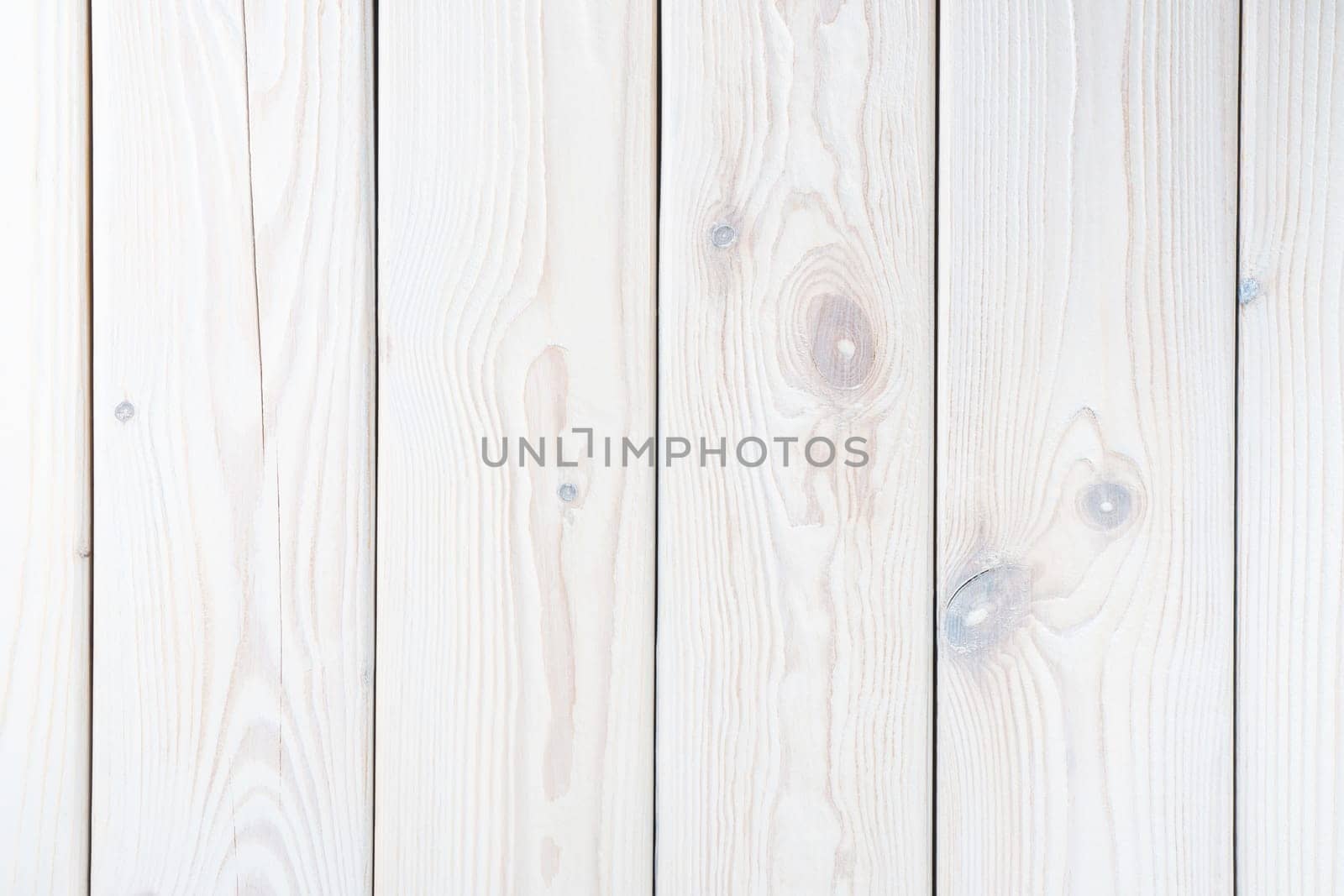 White striped planking. Wooden plank wall background for design and decoration. Empty space. Place for text. Light hardwood material. Vertical row of floorboards. Wooden textured, natural tree.