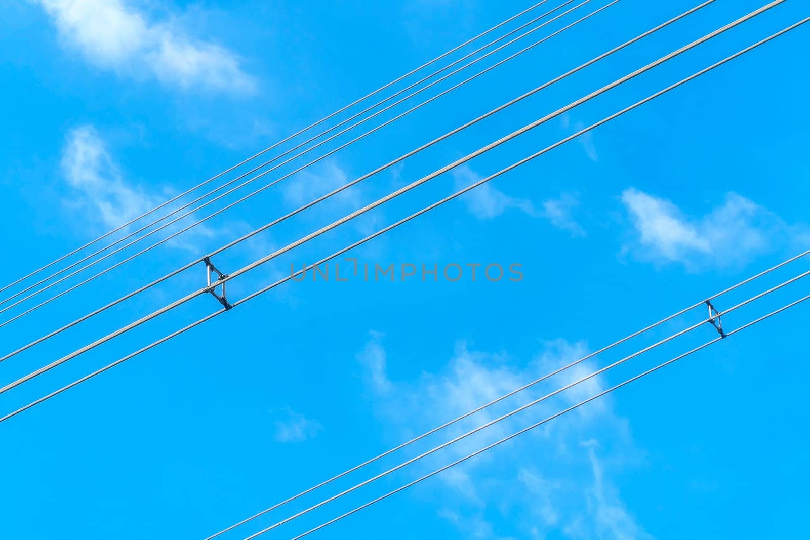 Wires power high and blue sky background.