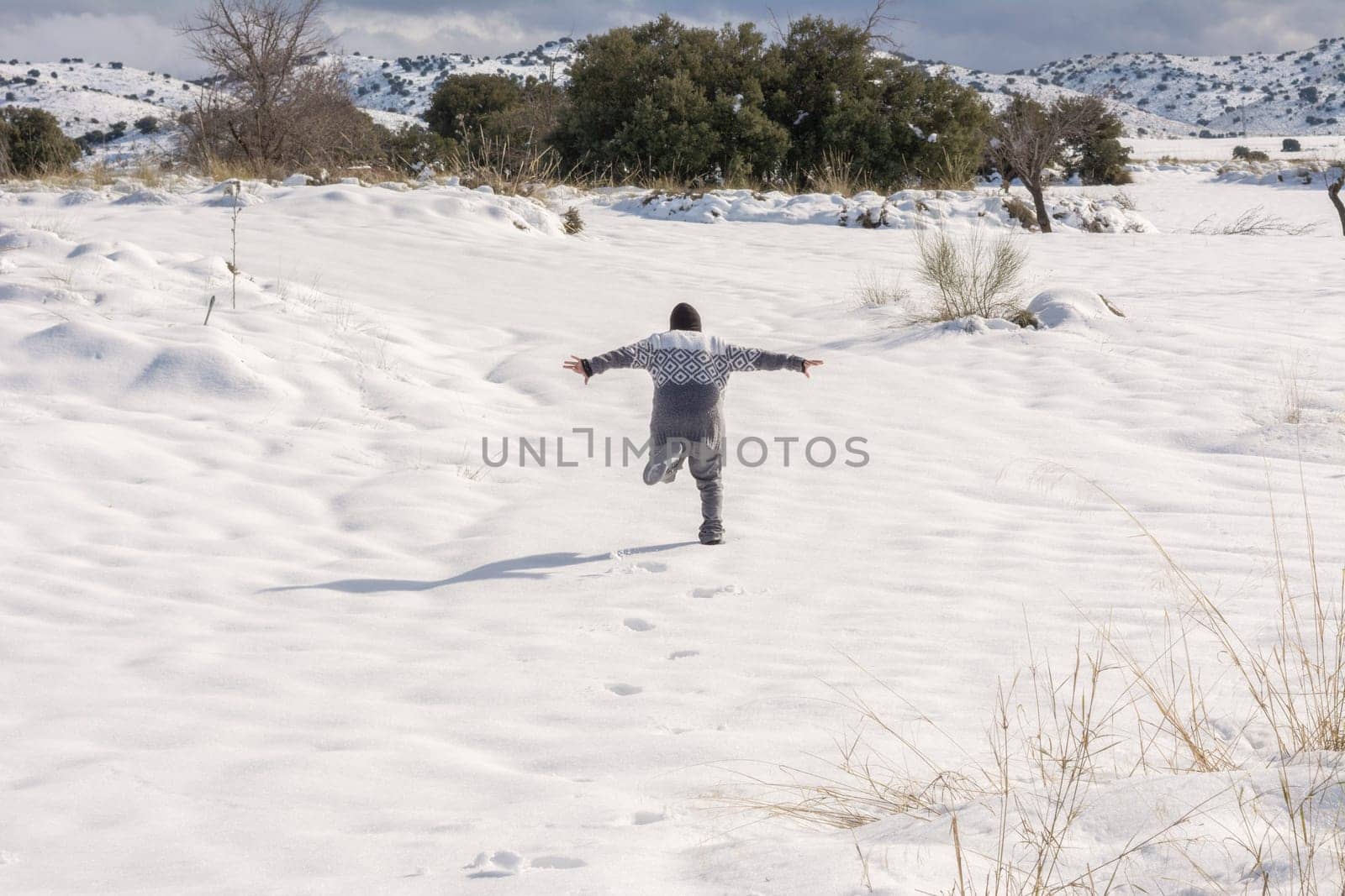 boy running and enjoying the snowy landscape