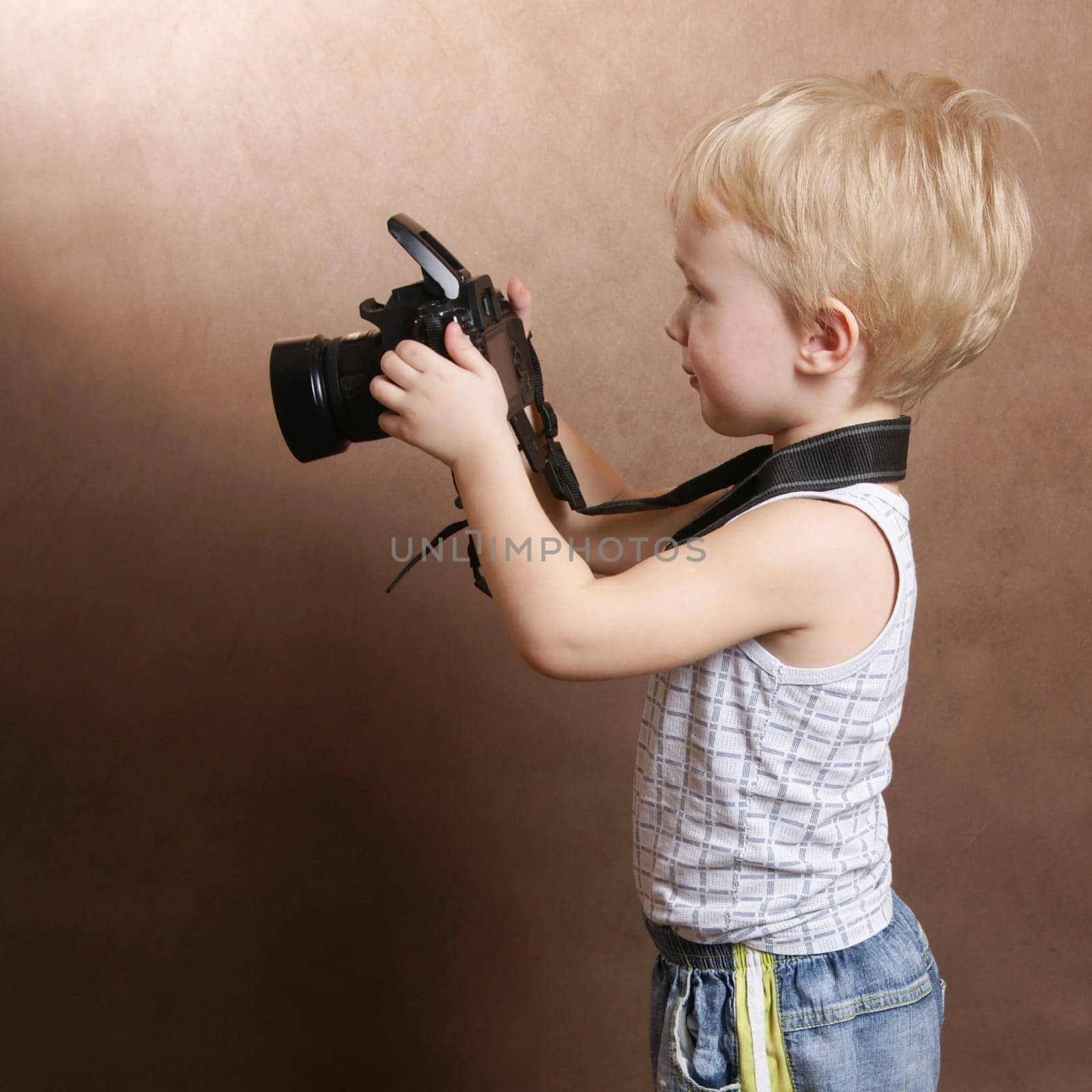 child in studio with professional camera