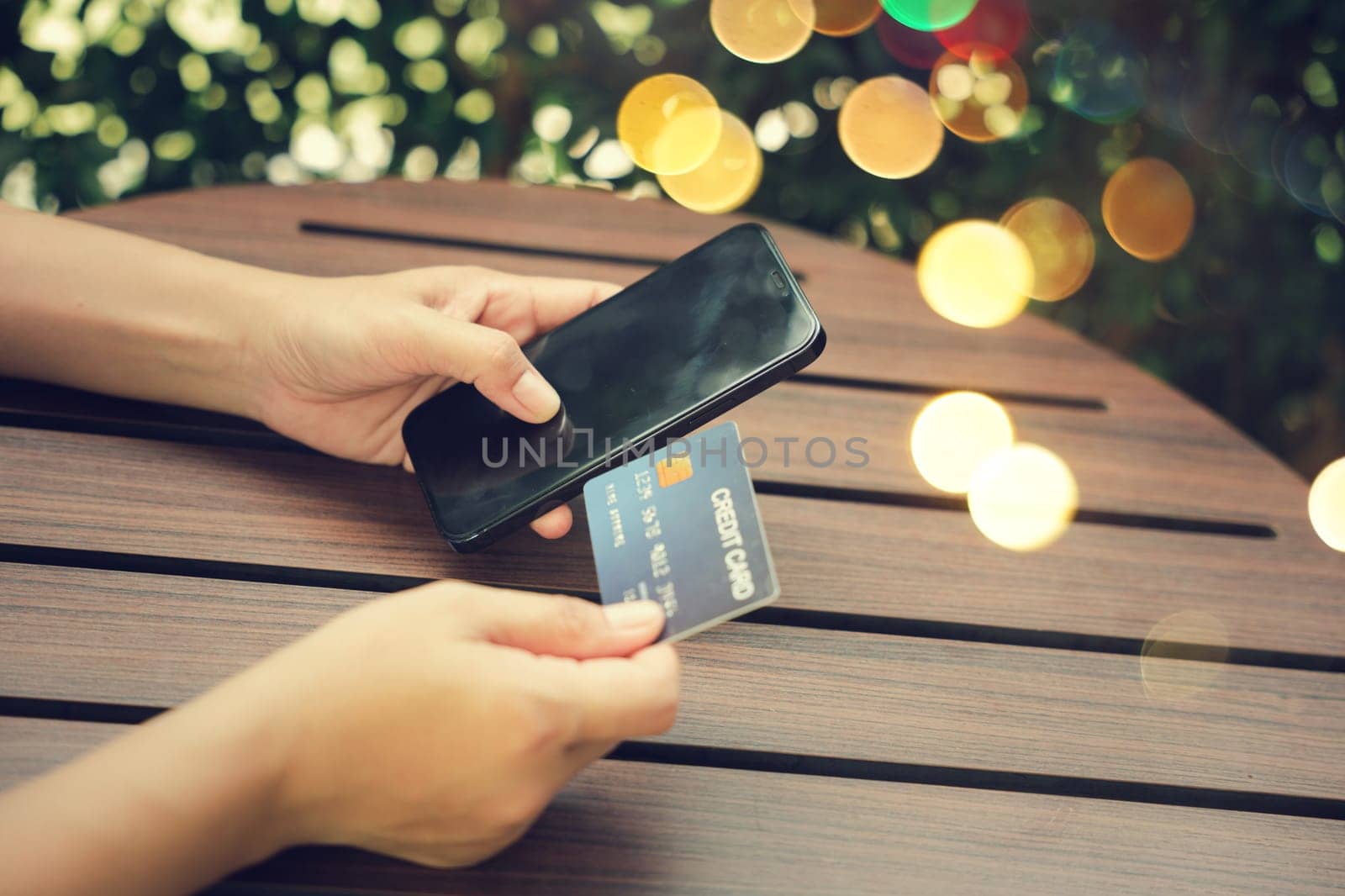 Close up hand of woman using credit card and smartphone during slide screen for finding product purchase buying payments online shopping, making secure internet payment browsing banking service