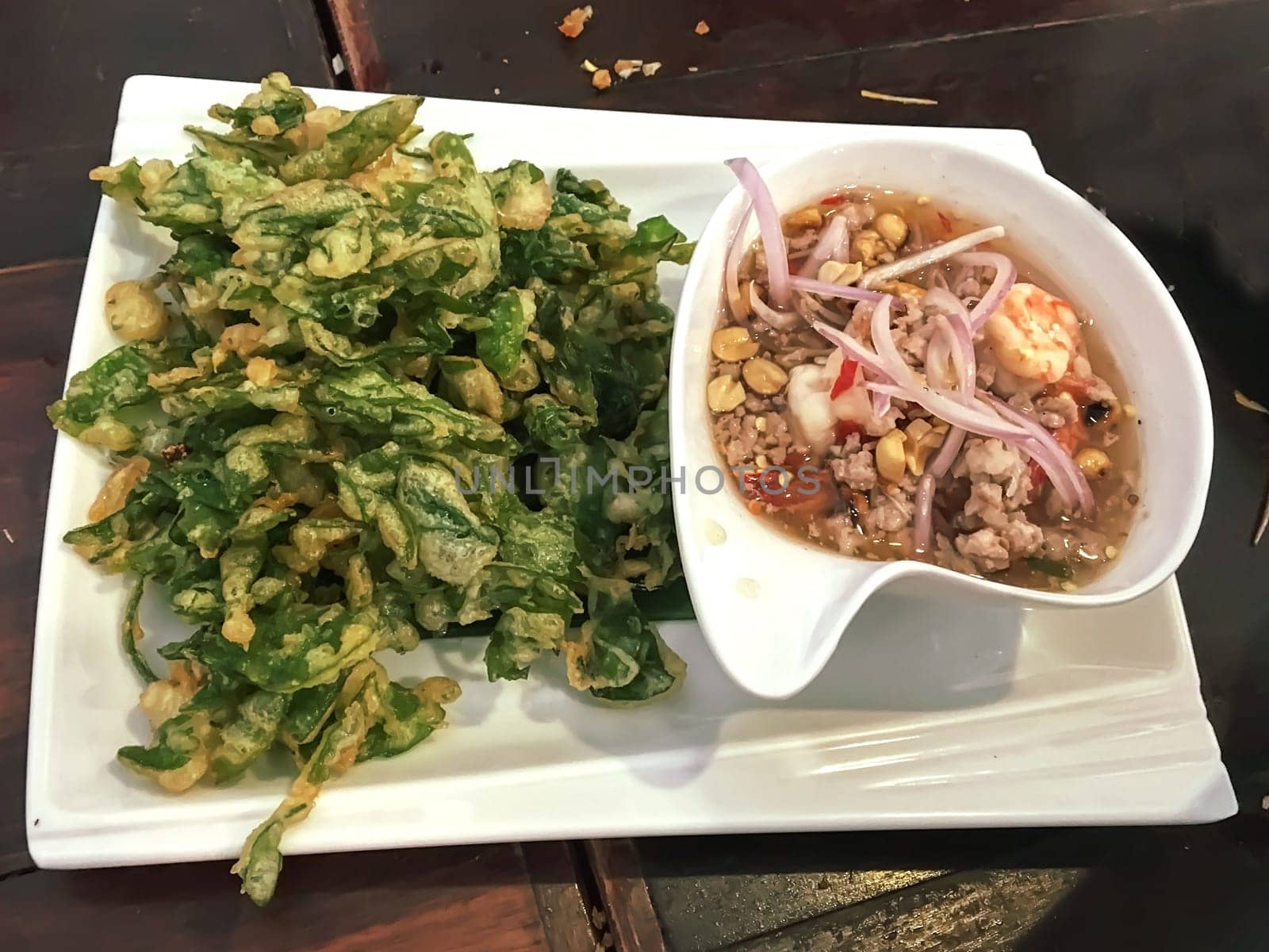 Crispy morning glory salad in a white plate.