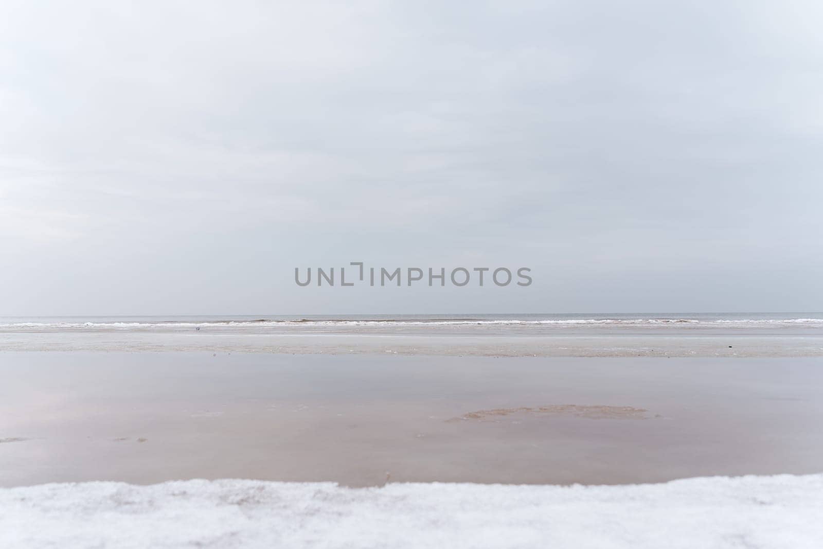 Winter seascape in the middle of a cloudy day. Baltic sea, Jurmala, Latvia.