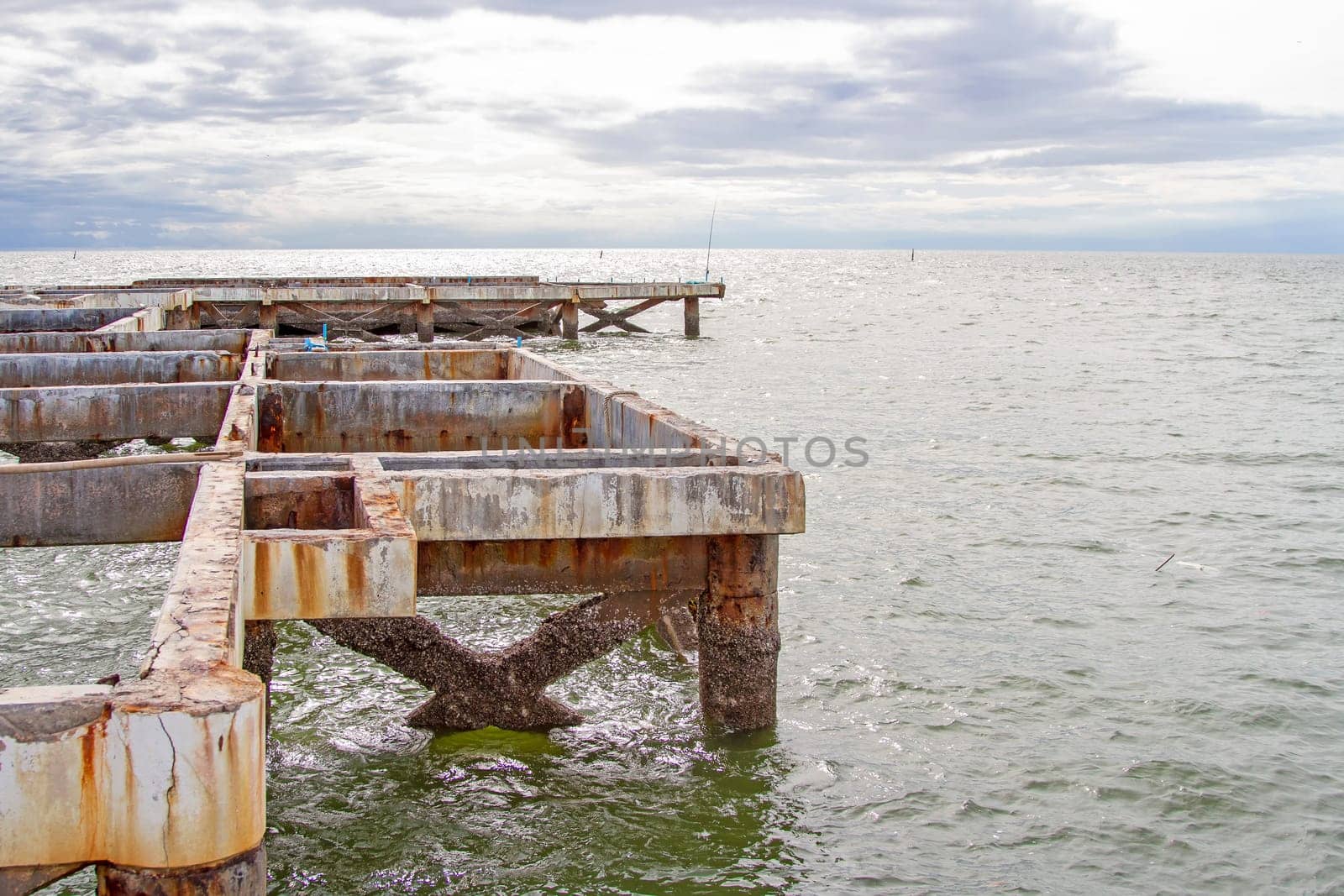 Pillars of old cement in the sea.