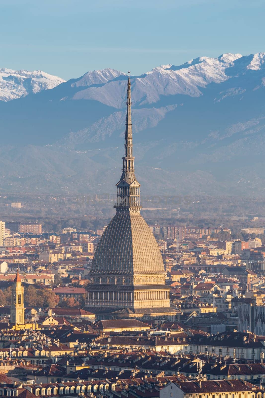 Turin, Italy - Circa November 2021: panorama with Alps and Mole Antonelliana,. Skyline of the symbol of Piedmont Region from Monte dei Cappuccini - Cappuccini's Hill. Sunrise light.
