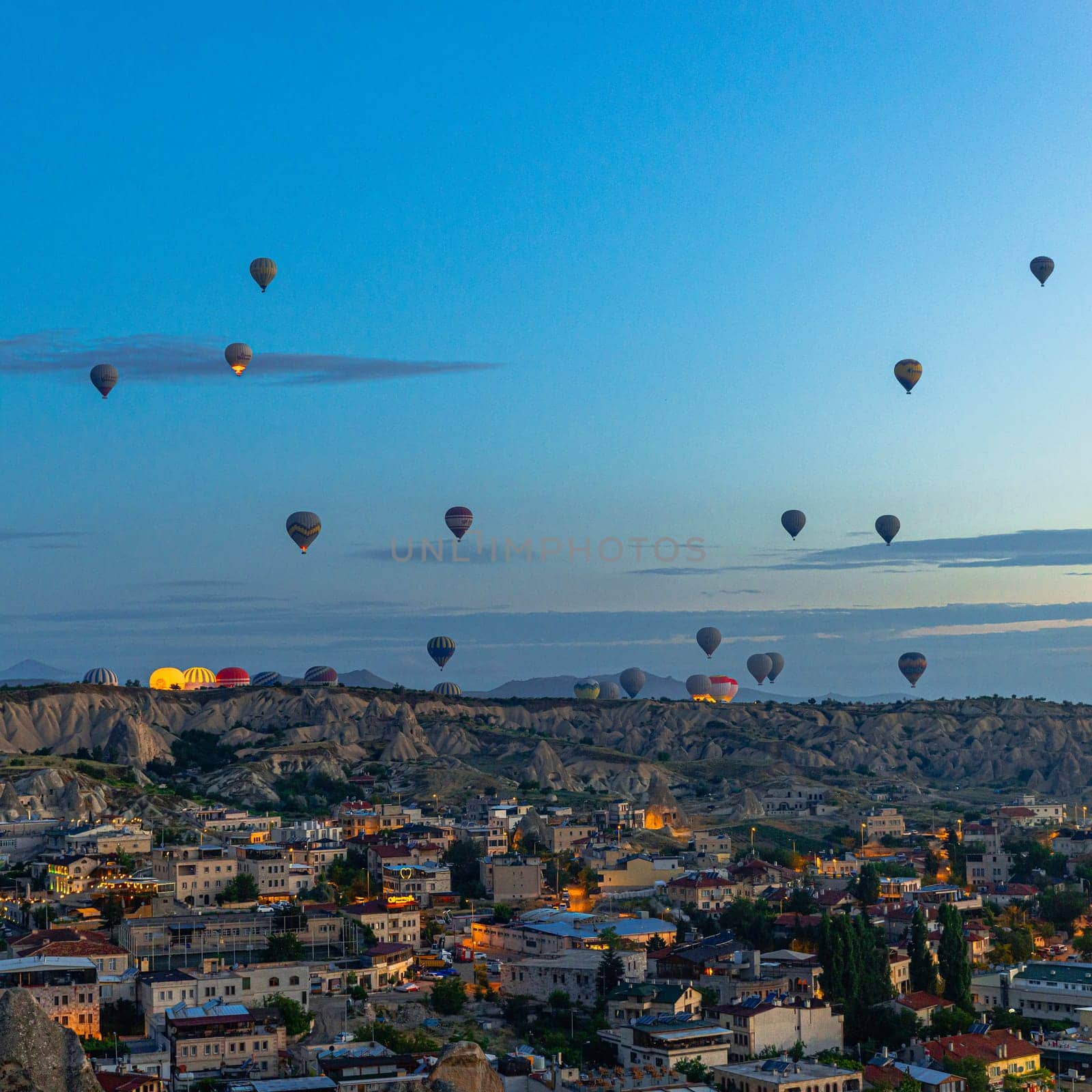 GOREME/TURKEY - June 29, 2022:  hot air balloons fly at sunrise