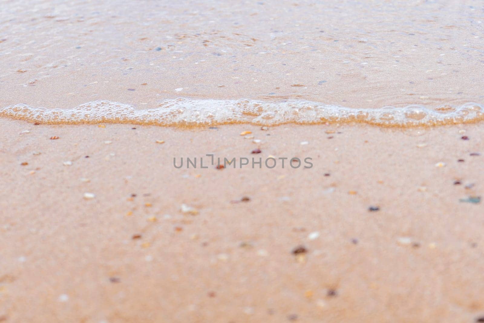 Waves on the sand and gravel nature texture