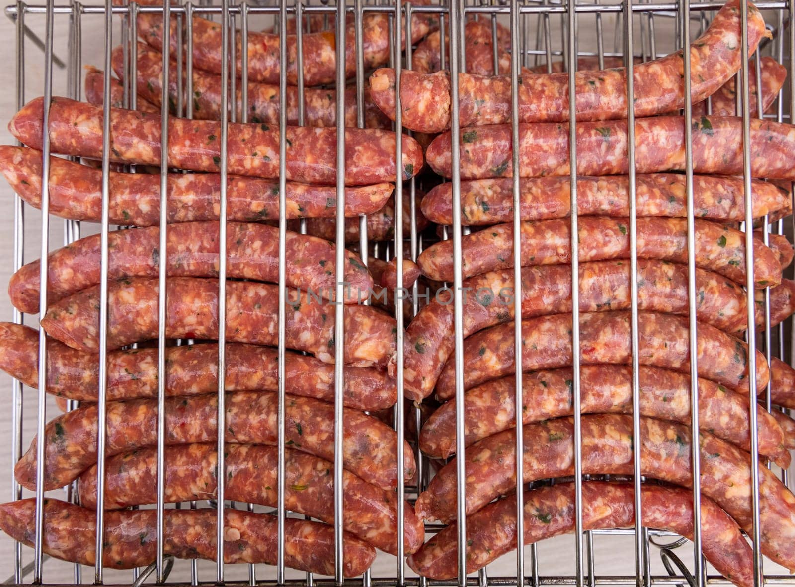Cooking Sausages on the charcoal grill top view, Italy. Traditional BBQ Grilling food outdoor with friends during summer time. Rustic style grilled Sausages close up