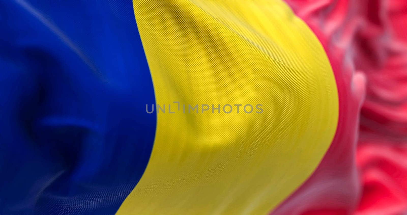 Detail of the Romania national flag waving in the wind. Romania is a Member State of the European Union. Fabric textured background. Selective focus. 3D illustration