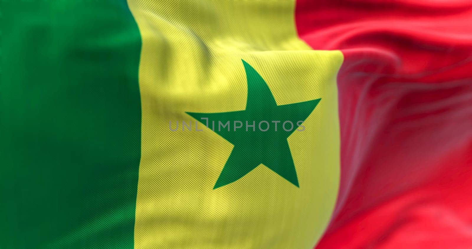 Detail of the Senegal national flag waving in the wind. The Republic of Senegal is a country in West Africa. Fabric textured background. Selective focus. 3D illustration