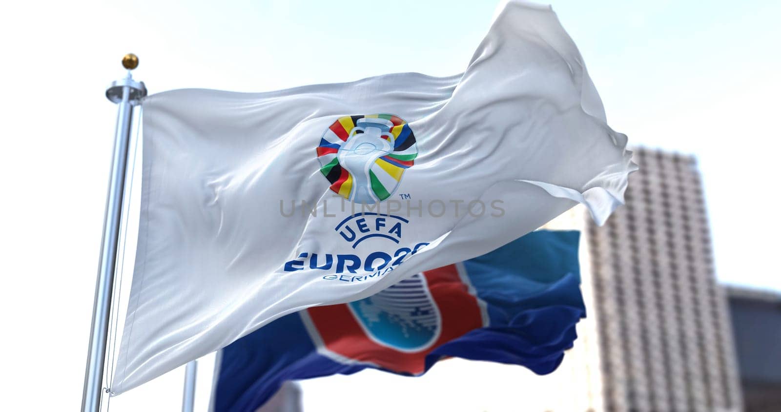 Berlin, Ger, Oct. 2022: The flag of UEFA Euro 2024 and UEFA flying in the wind. The 17th edition will take place from 14 June to 14 July 2024 in Germany. Selective focus. International sport event