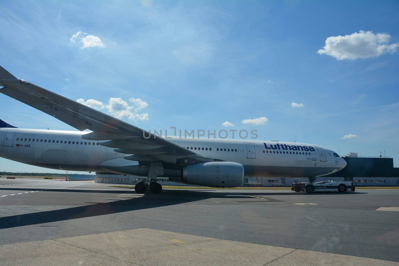 Frankfurt Airport Germany August 02, 2022 - Lufthansa machine being pulled onto the runway by a vehicle with blue sky