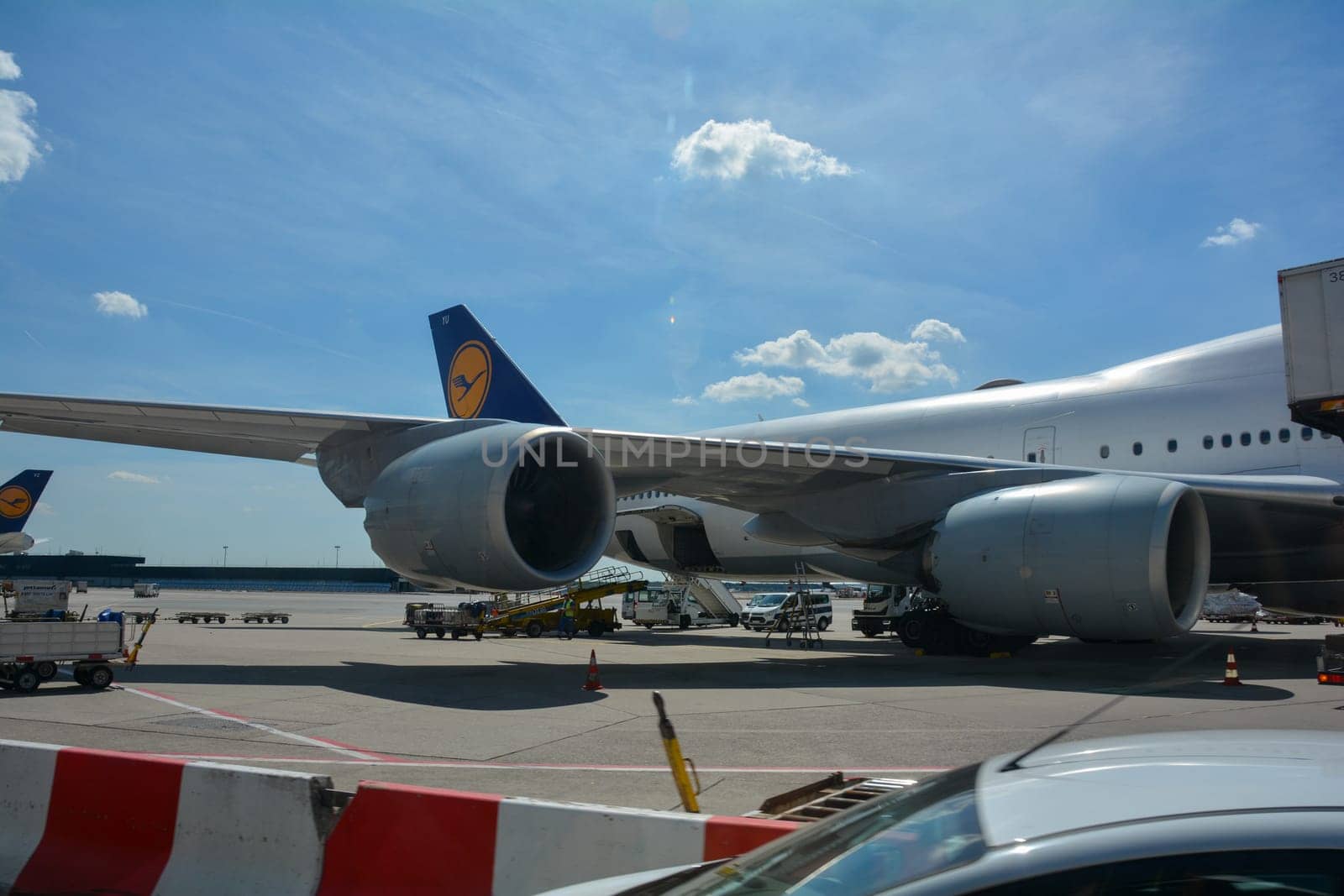 Frankfurt Airport Germany August 02, 2022 - Lufthansa machines at the terminal with some luggage trolleys