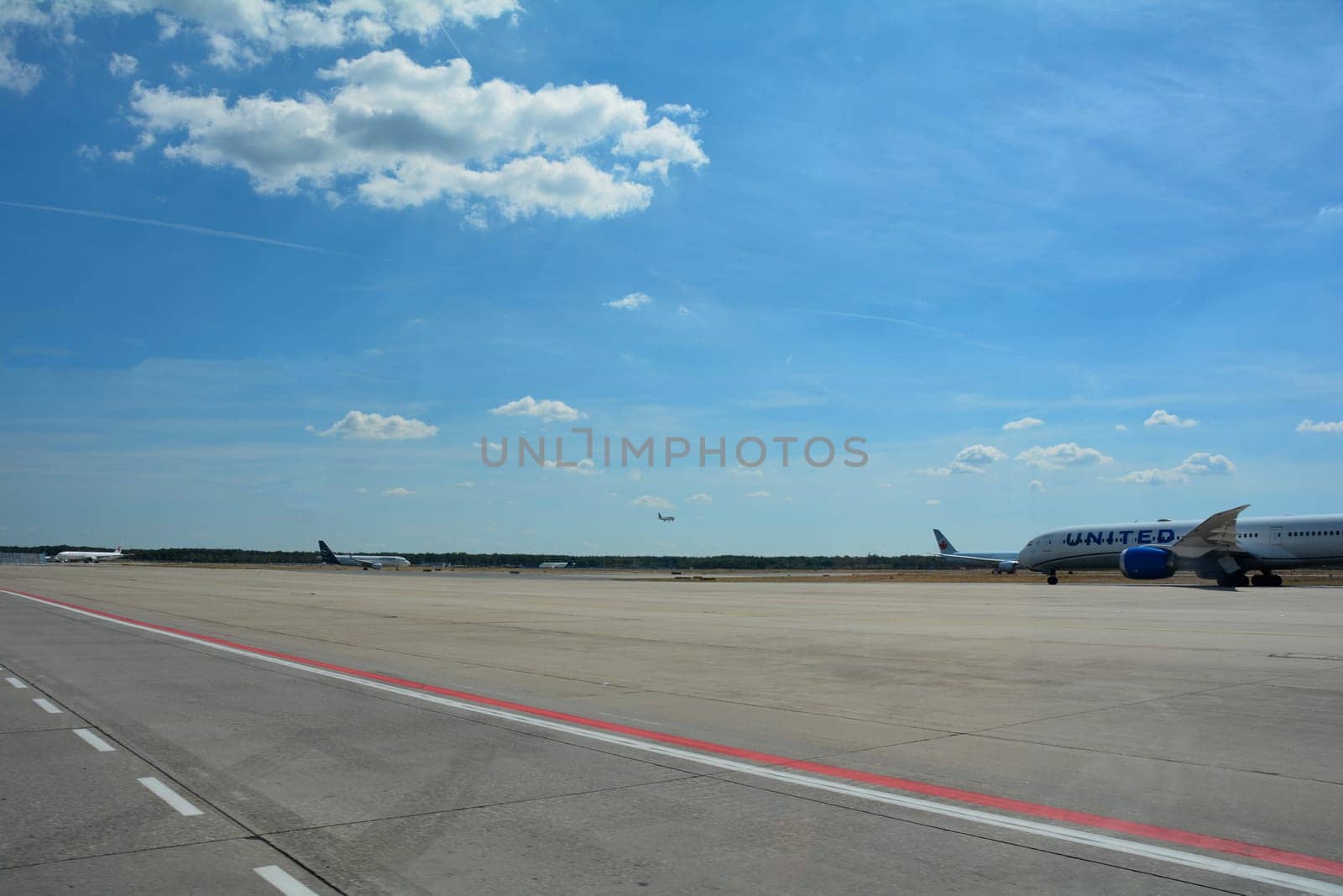 Frankfurt Airport Germany August 02, 2022 - United airplane on the way to the runway with lots of tarmac and blue sky