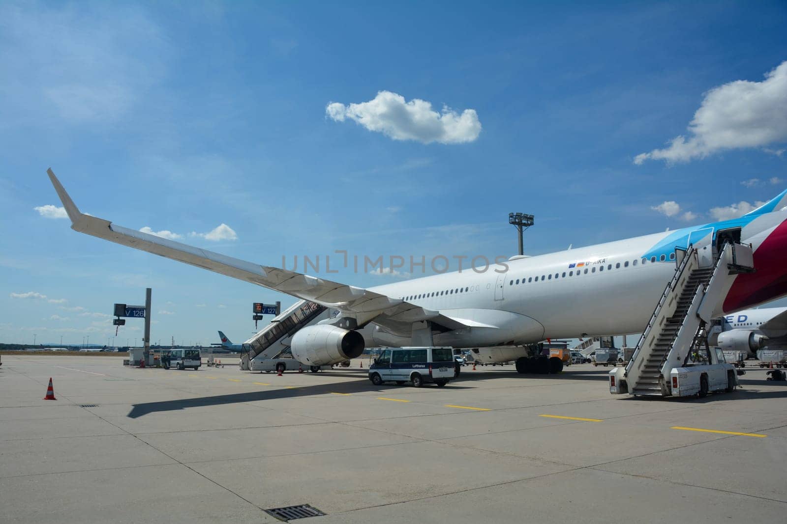 Frankfurt Airport Germany August 02, 2022 - Eurowings Discover airplane with passenger stairs and blue sky