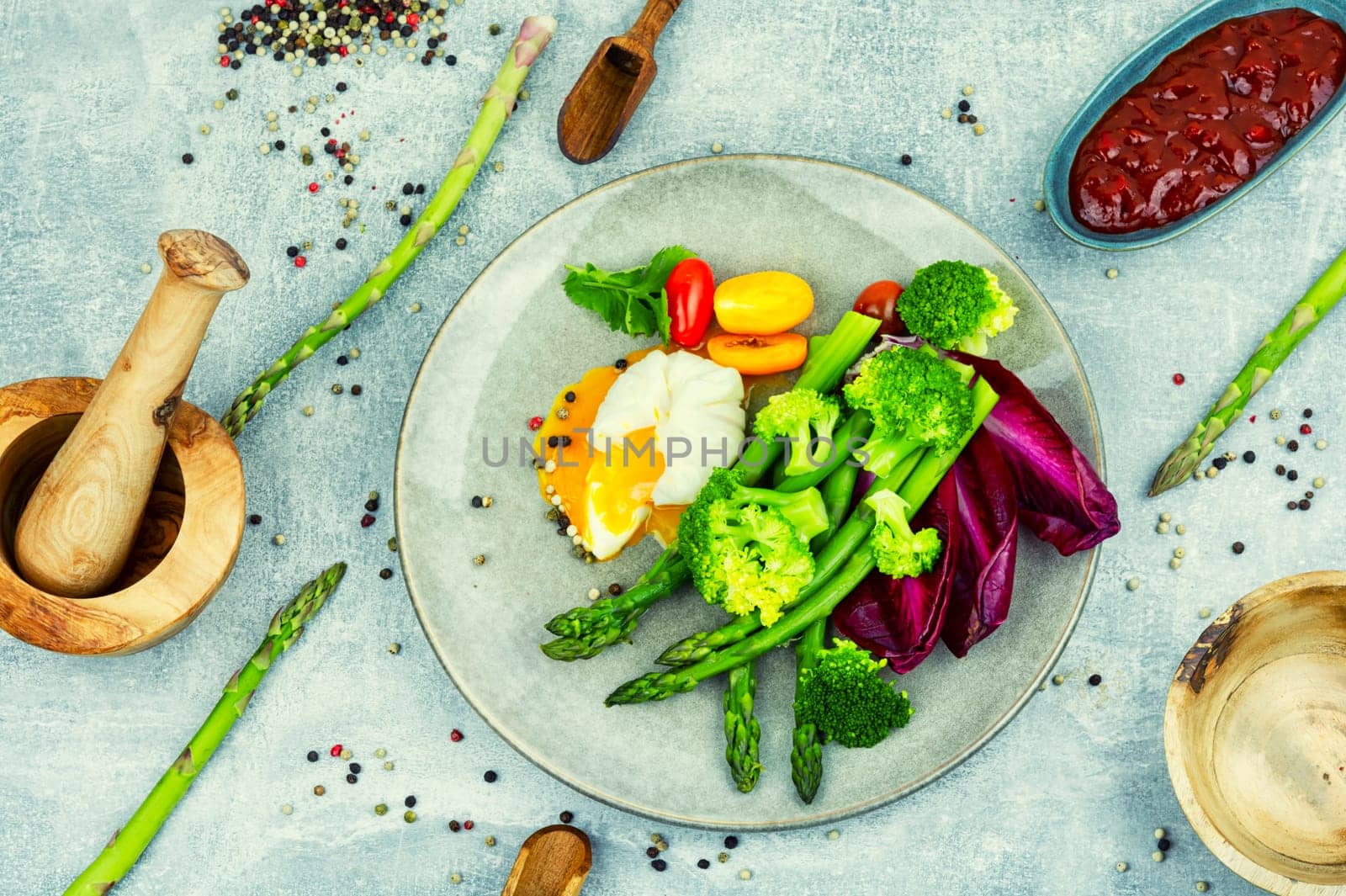 Diet salad with asparagus, poached egg and lettuce, tomato.