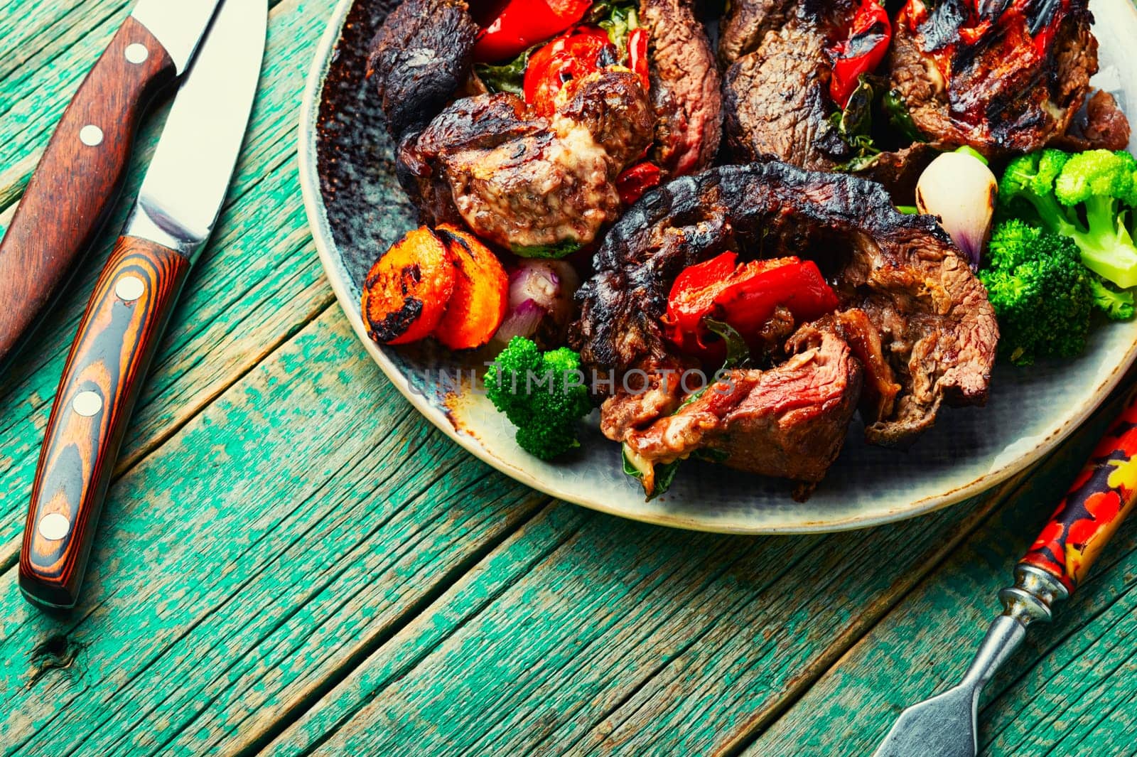 Deep fried meat with vegetable garnish. Roasted meat and vegetables. Copy space