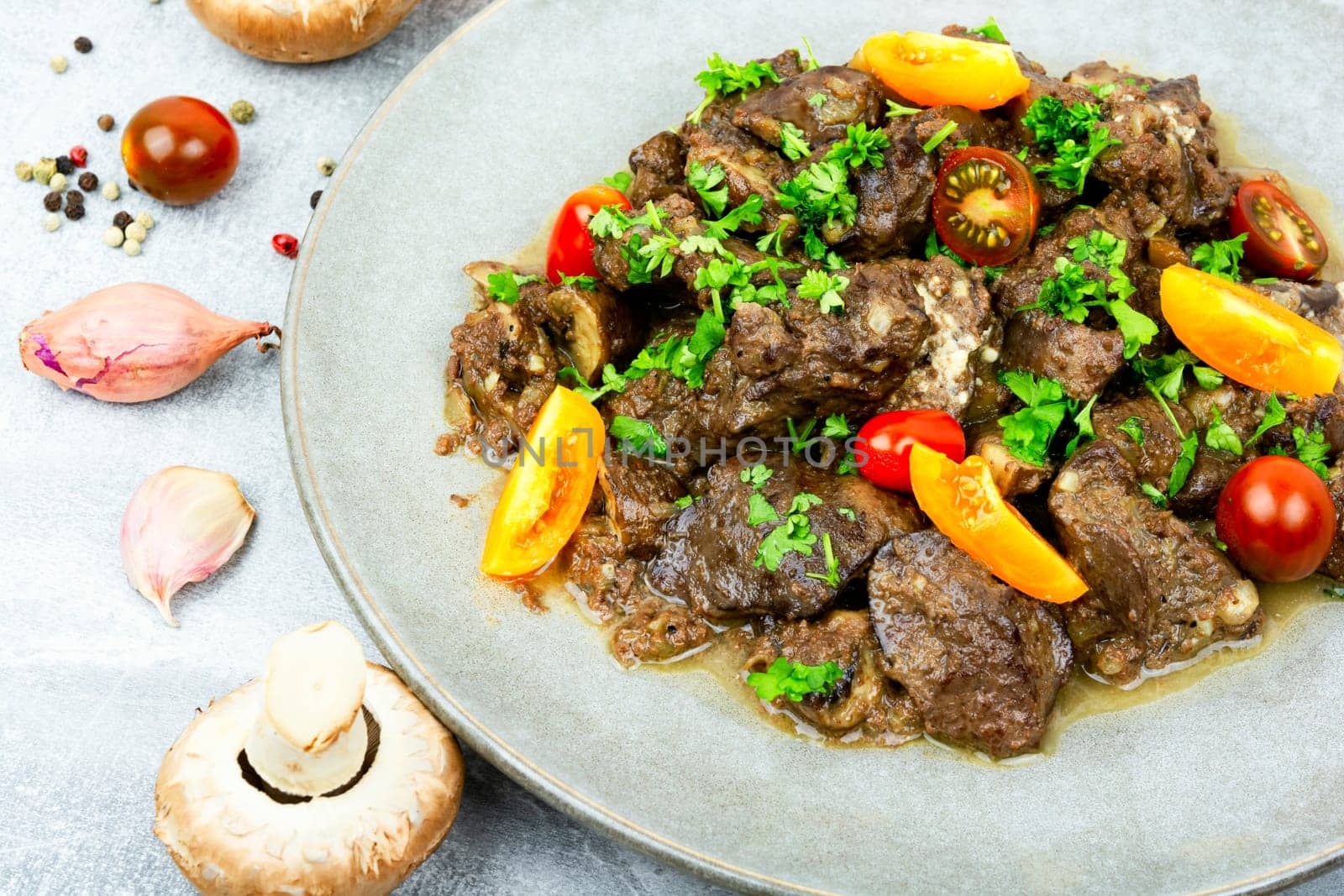 Chicken liver fried with mushrooms and tomatoes. Tasty liver in Georgian