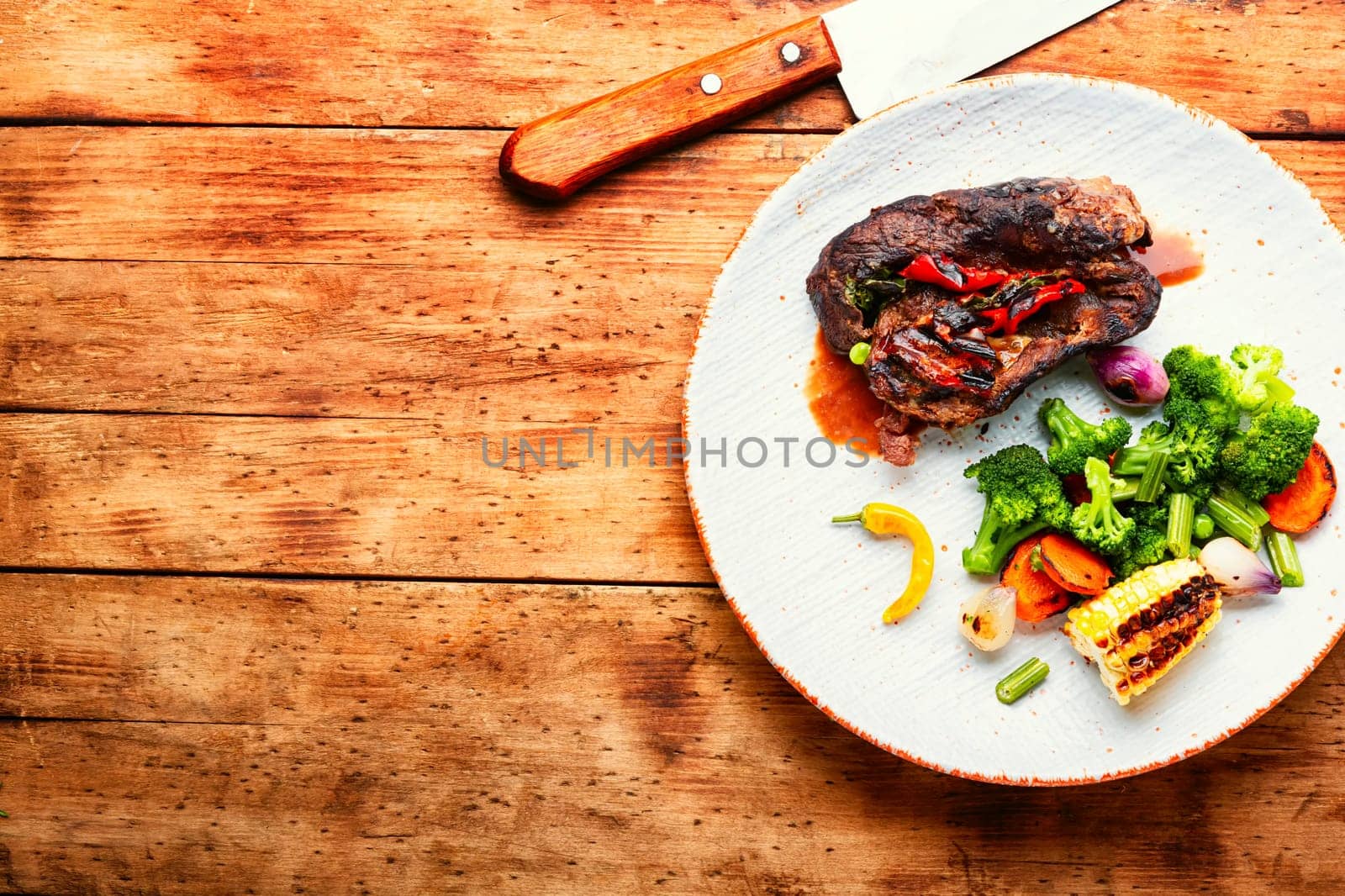 Deep fried meat with vegetable garnish. Roasted meat and vegetables. Copy space