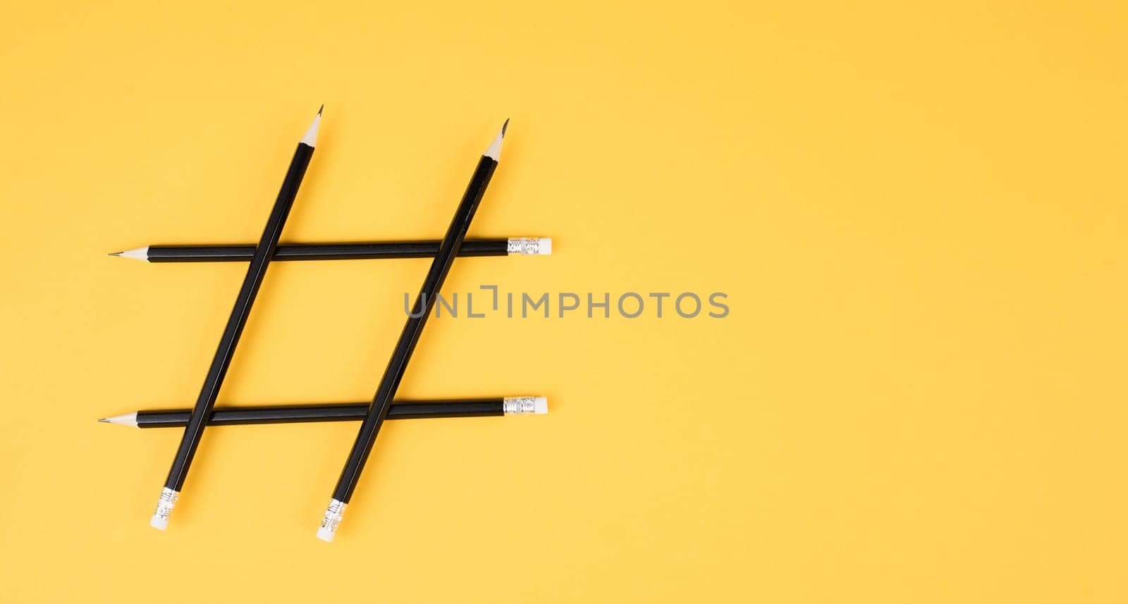 Hashtag made from pencils, social media communication, influencer and followers, viral content trend, yellow color