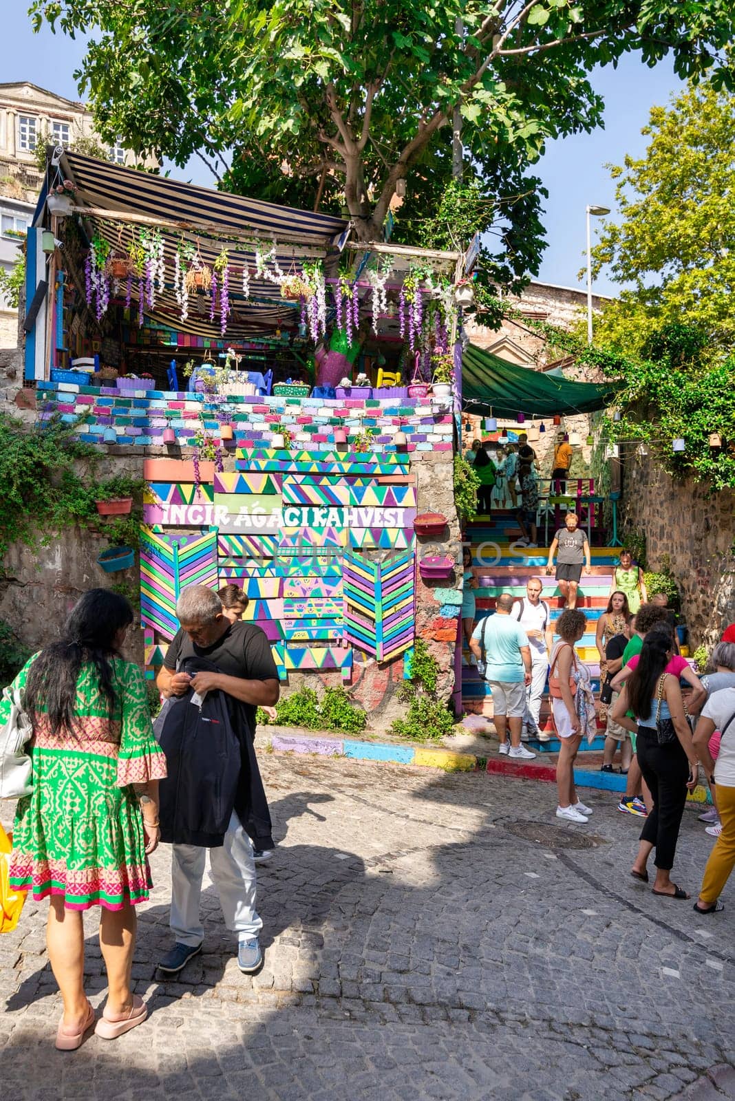 Istanbul, Turkey - August 28 2022: Tourists visiting famous traditional cafe decorated with multicolored panels and colorful stairs, suited in Balat District