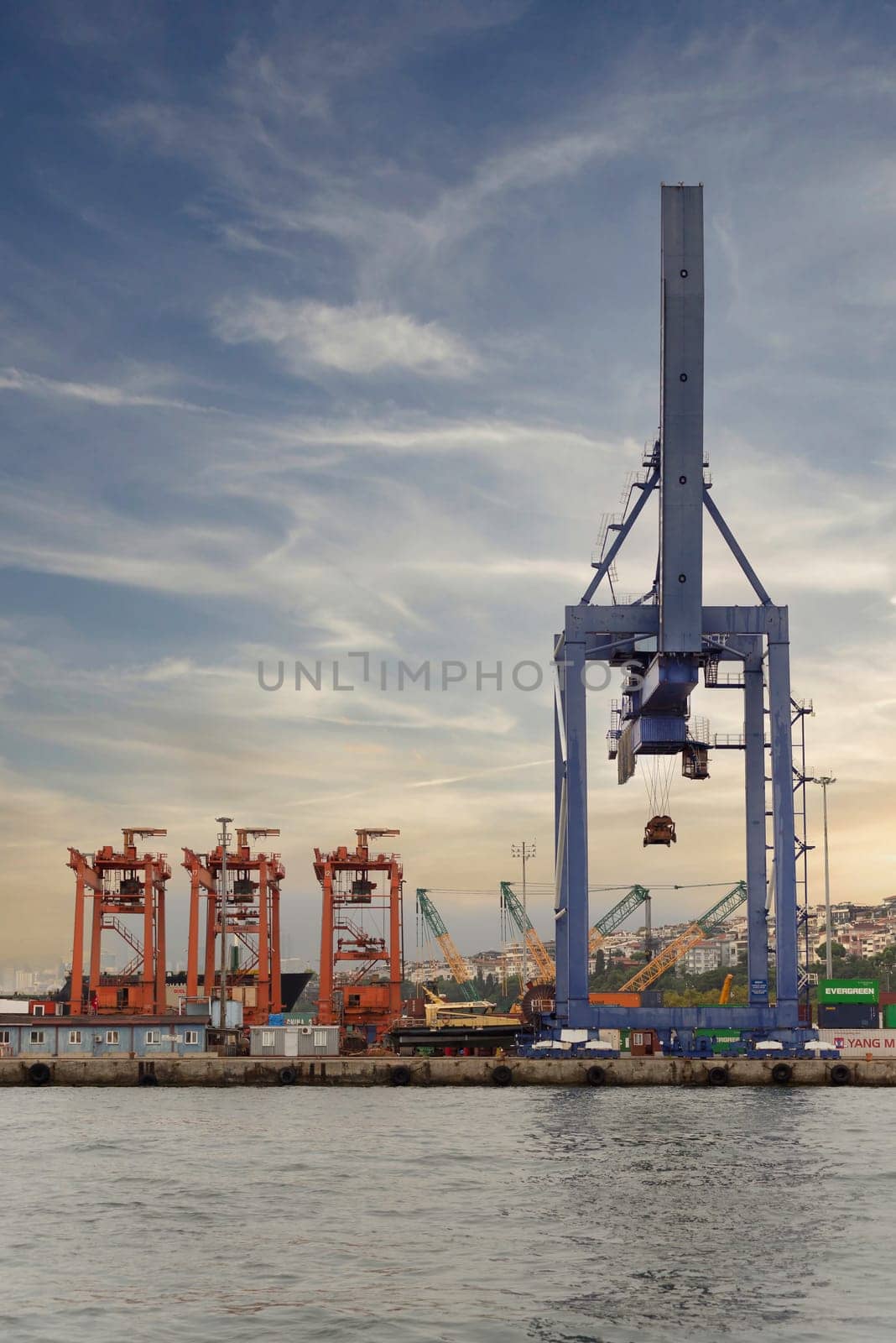 Istanbul, Turkey - August 25, 2022: Day shot of the cranes in the shipyard of the Port of Haydarpasha, Istanbul, Turkey with city view in the background