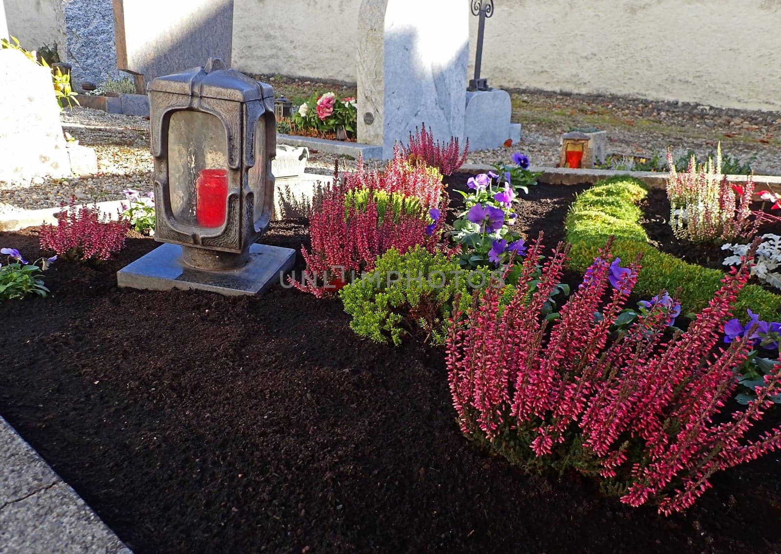 Beautifully decorated graves in a cemetery on All Saints Day in autumn