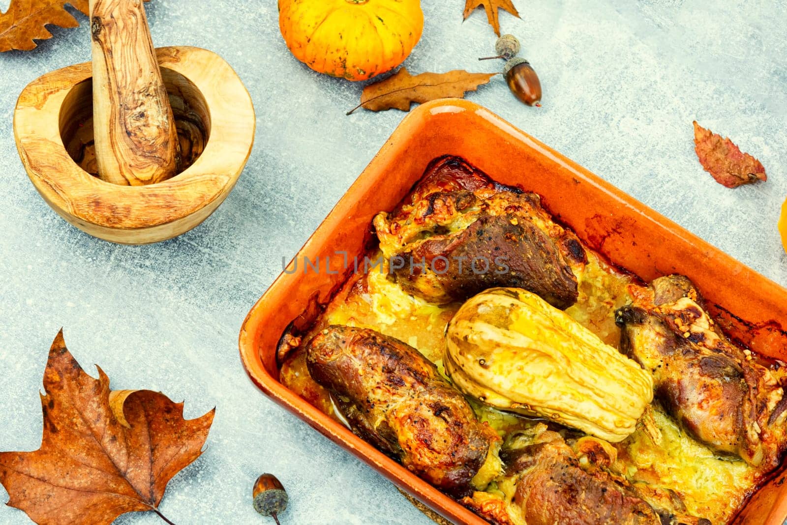 Tasty baked meat roulade stuffed with pumpkin in the oven dish. Autumn recipe.