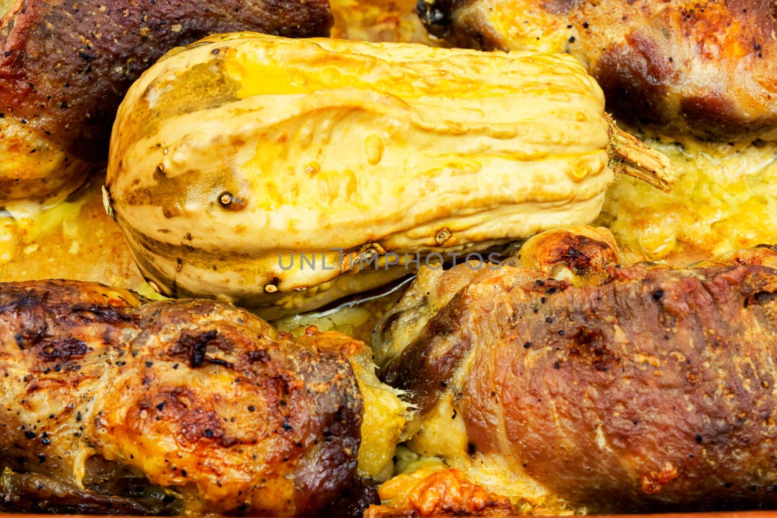Tasty baked meat roulade stuffed with pumpkin in the oven dish. Autumn recipe.