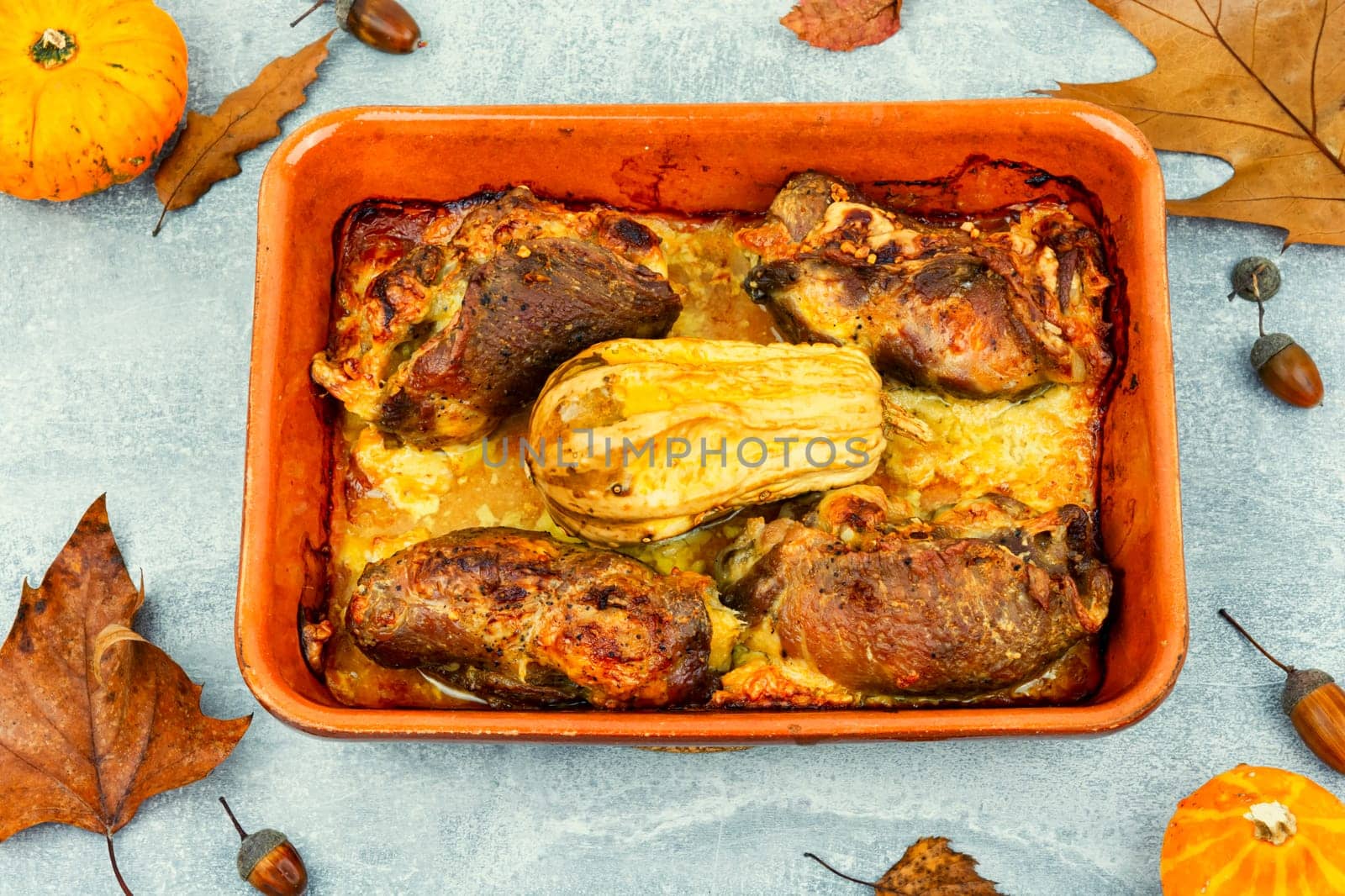 Tasty baked meat roulade stuffed with pumpkin in the oven dish. Autumn recipe.