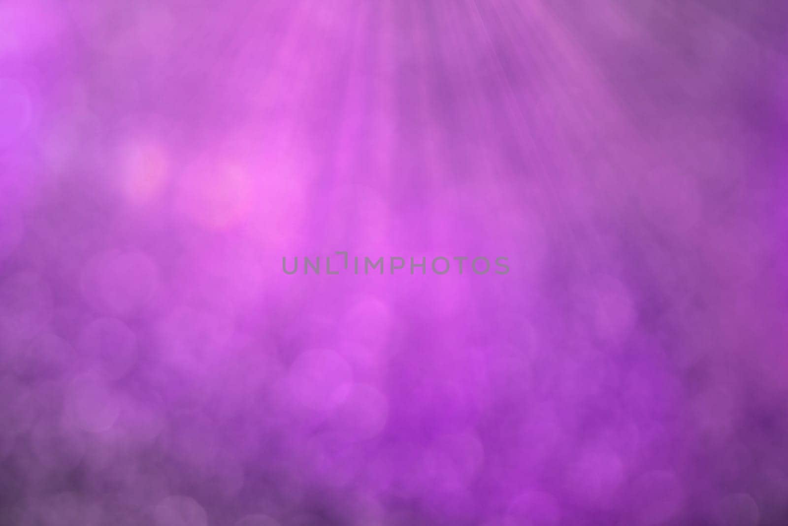 Purple bokeh background with defocused round lights and sunbeams, flare overlay