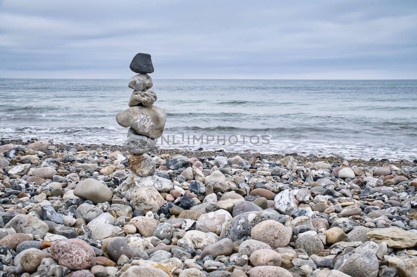 Stone pyramid on the beach overlooking the sea. Danish coast. Scandinavia landscape photo
