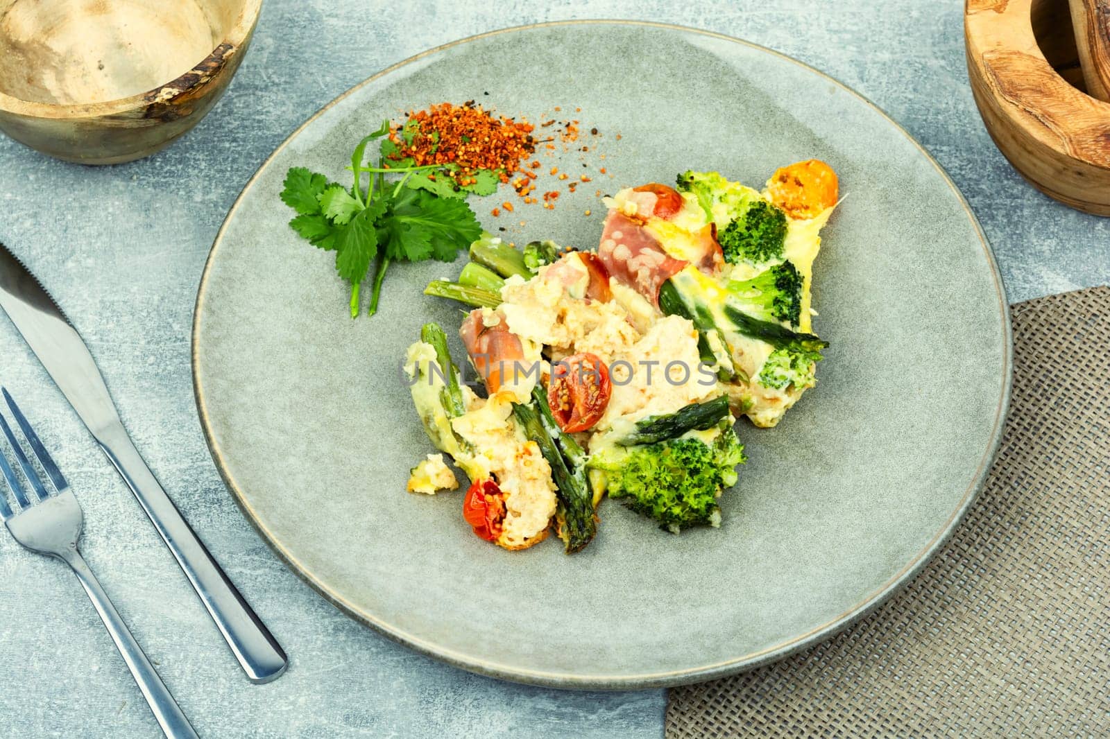 Asparagus wrapped in bacon with grated parmesan cheese.Food background