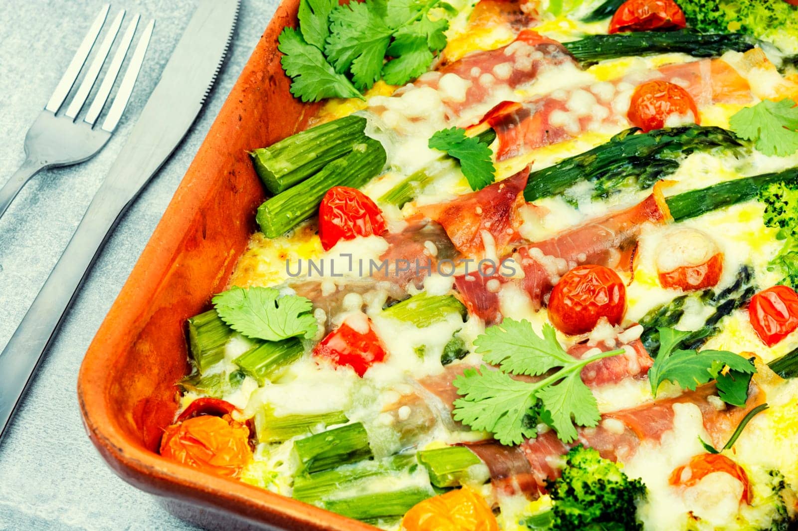 Asparagus wrapped in bacon with grated parmesan cheese.Food background