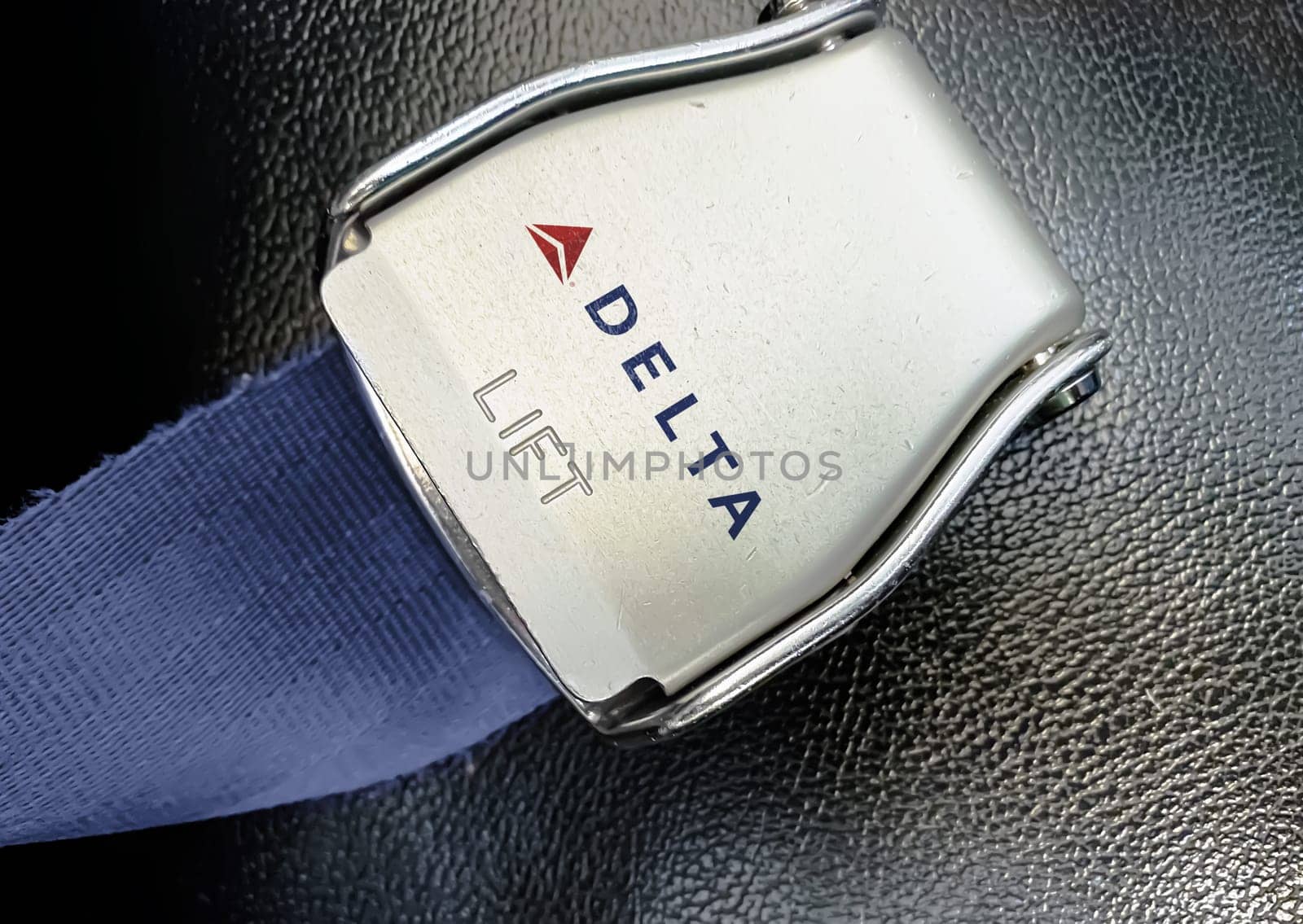 Atlanta, US, Nov 2022: detail of the buckle of the seat belt with the logo of Delta Airlines on an empty seat. Singapore Airlines is the flag carrier airline of Singapore. Illustrative editorial