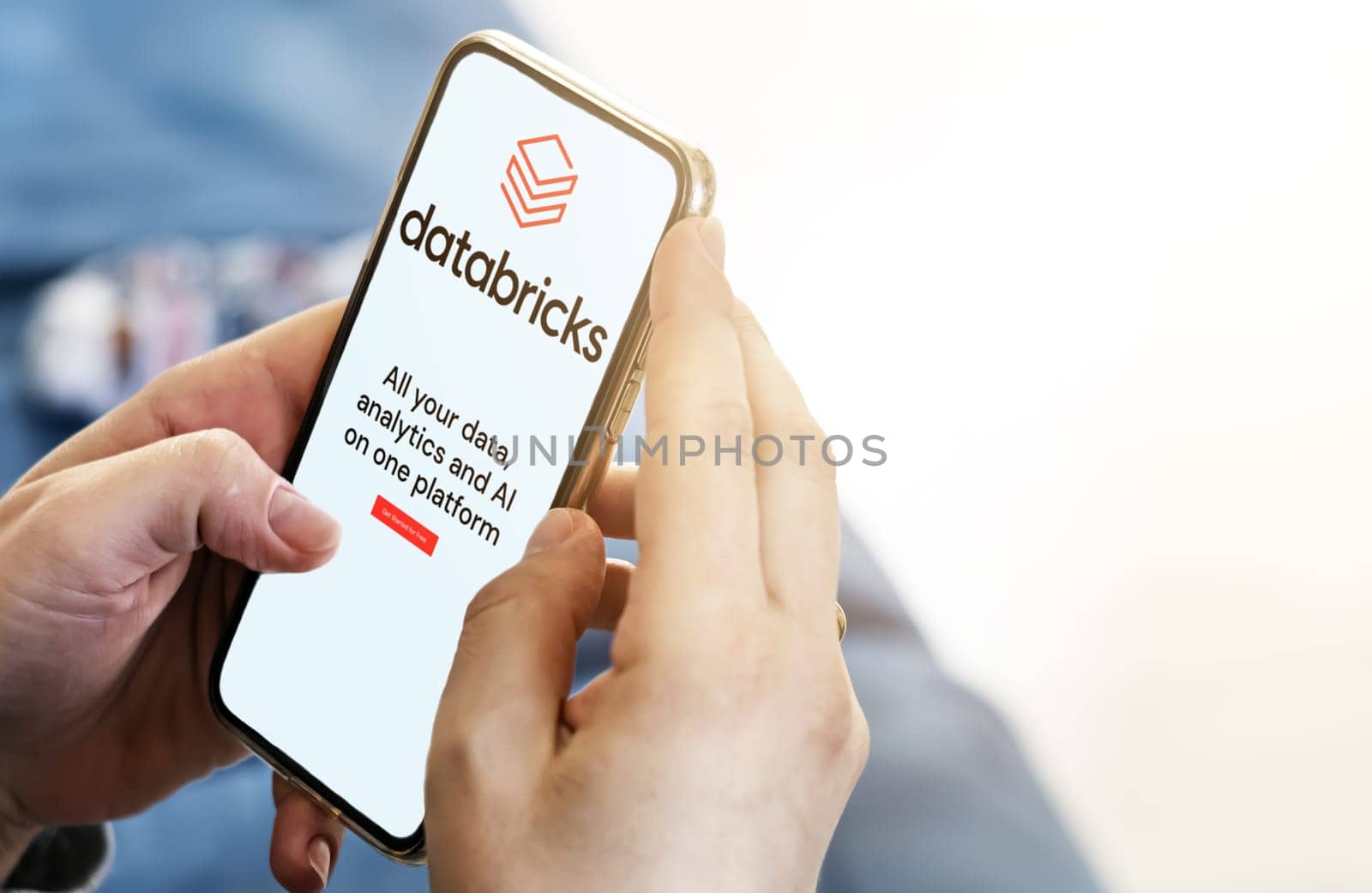 San Francisco, CA, US, May 2022: Female hands holding a phone with Databricks mobile app on screen. Databricks is an enterprise software company. Illustrative editorial