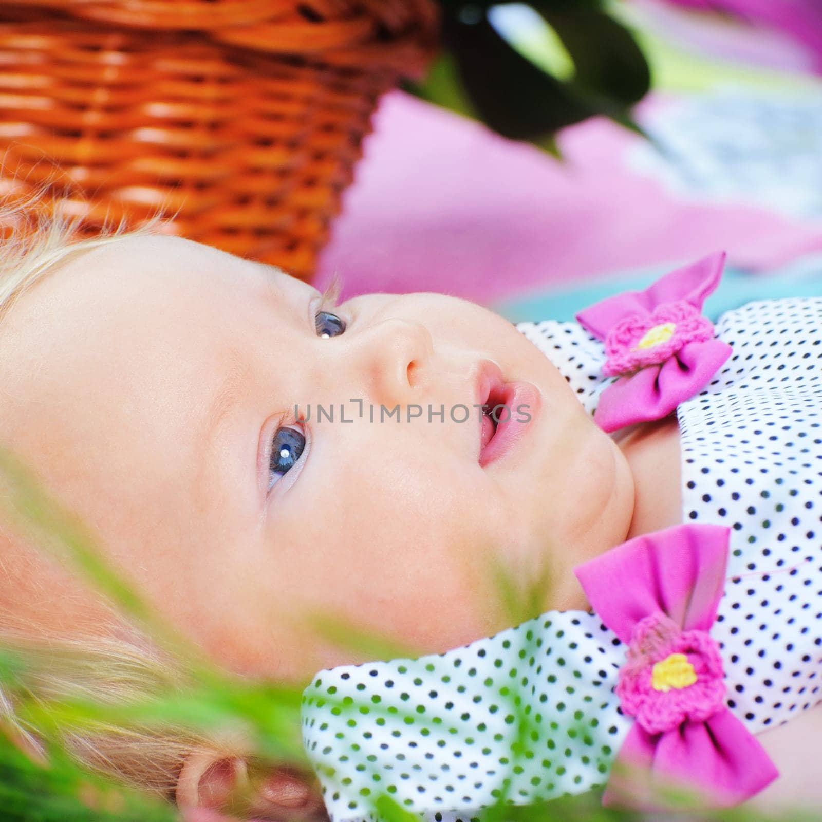 Closeup portrait beautiful little baby girl lying in the grass
