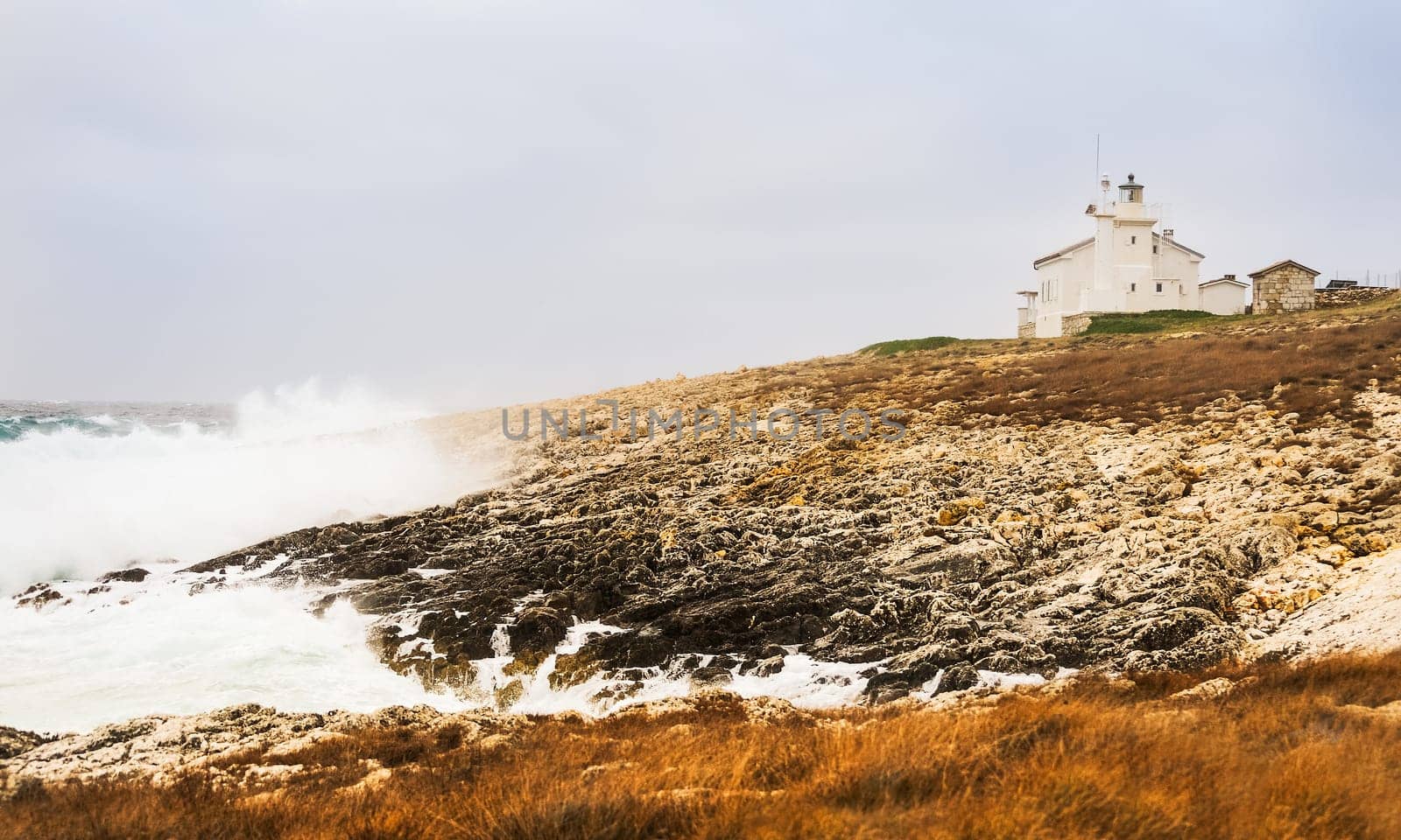 Surf by the sea at lighthouse in Istria