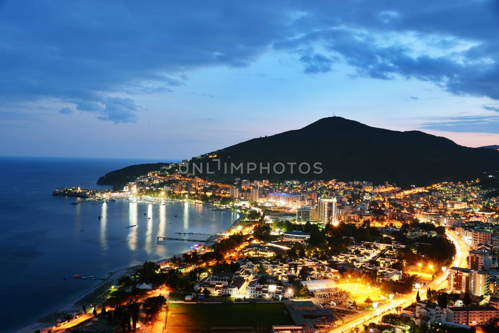 Aerial view of Budva, Montenegro on Adriatic coast after sunset.