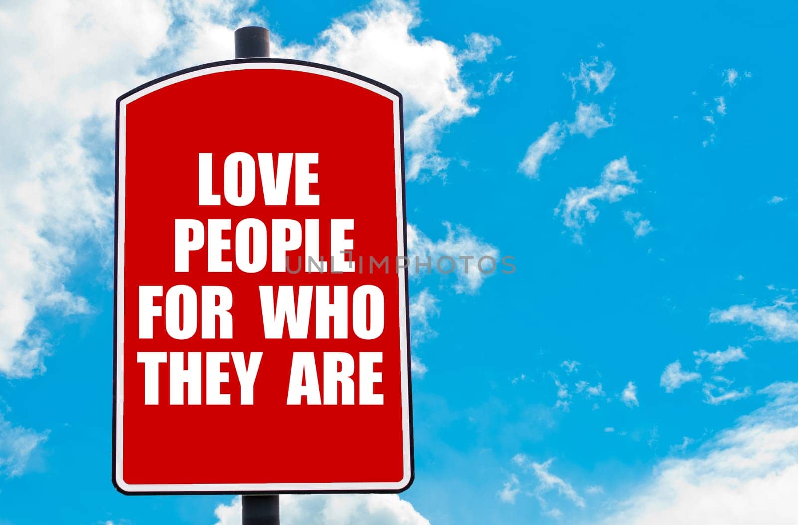 Love People For Who They Are motivational quote written on red road sign isolated over clear blue sky background. Concept  image with available copy space
