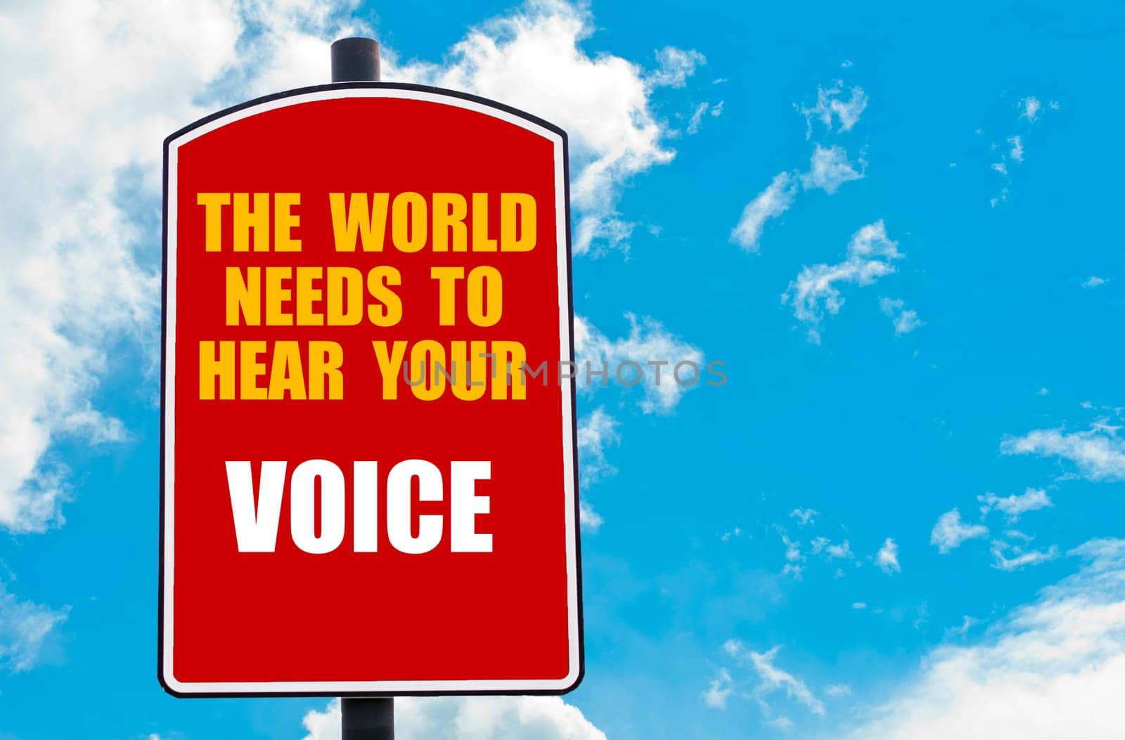 The World Needs to Hear Your Voice motivational quote written on red road sign isolated over clear blue sky background. Concept  image with available copy space