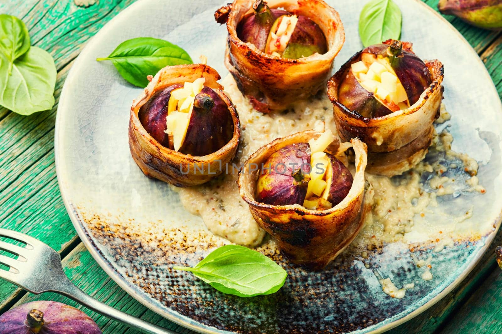 Baked figs with cheese and bacon. Festive autumn snack.