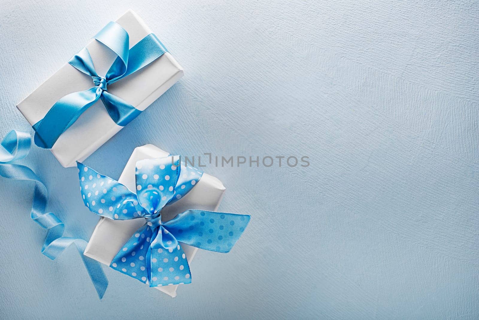 Holidays blue background with gift box. Top view with copy space