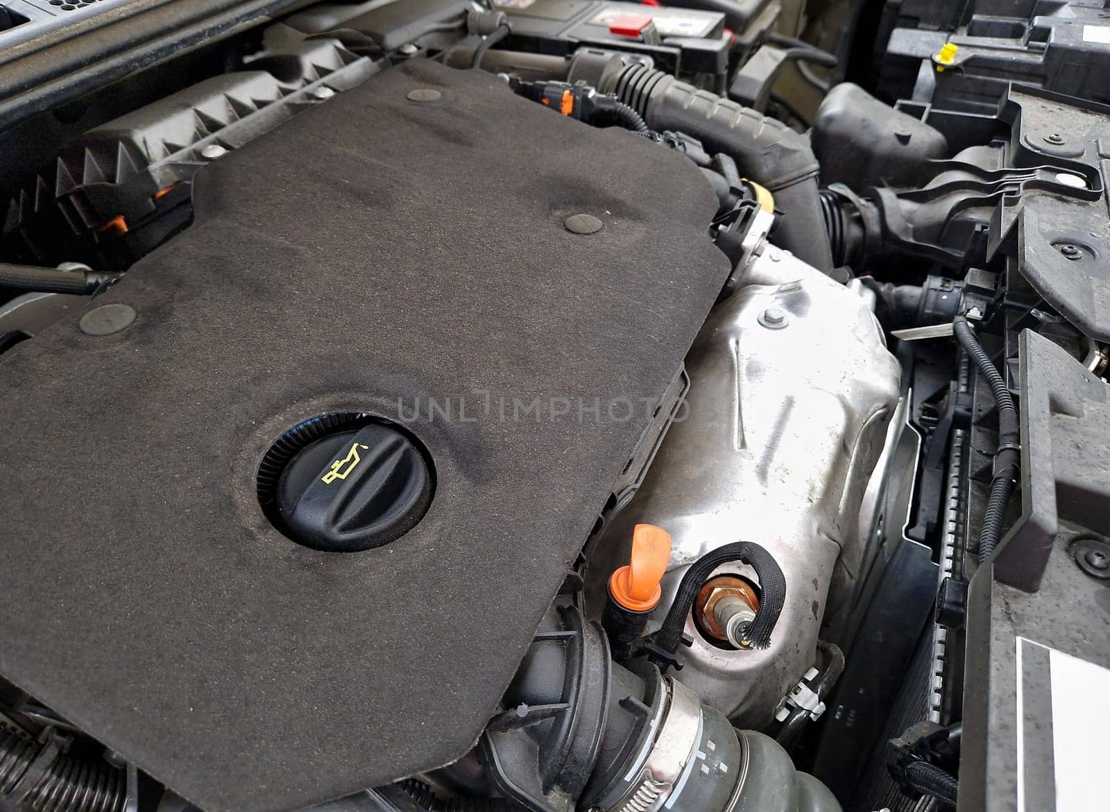 Engine bay of modern car. View of the car engine under hood. Car engine with oil cap.