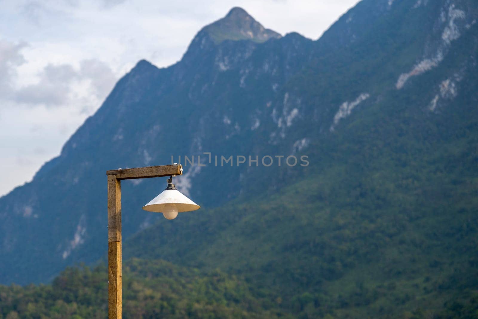 Old wooden lamp with mountain background