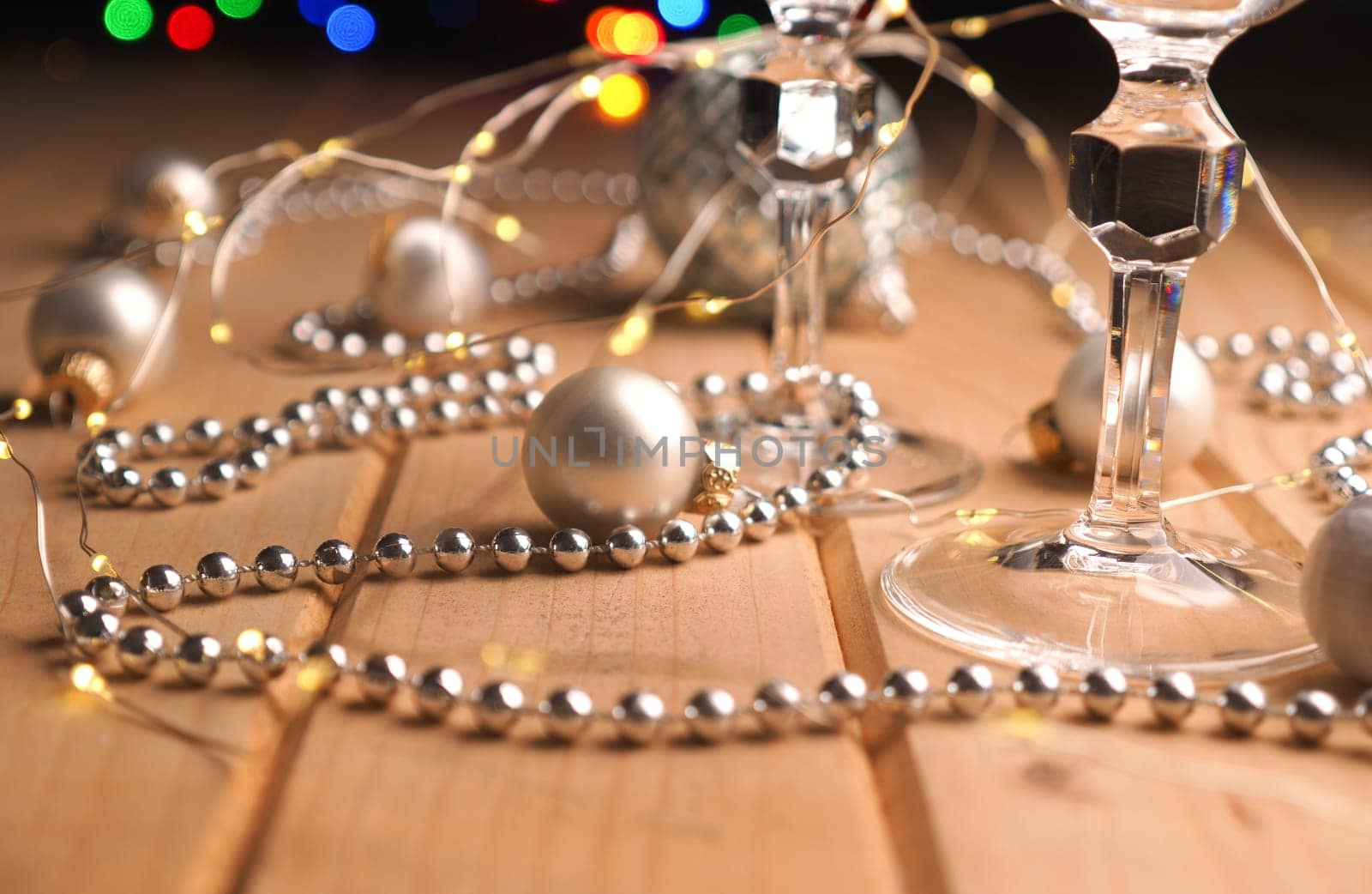 Two glasses of champagne on a wooden table with festive decoration, Christmas or New Years concept