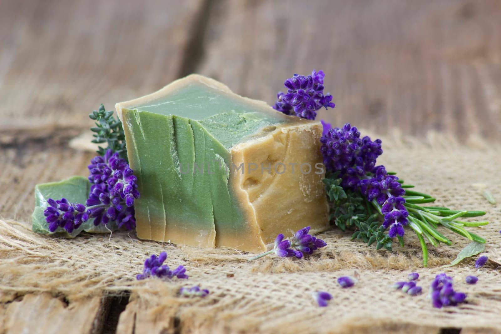 Natural handmade soap with herbs on rustic wooden background